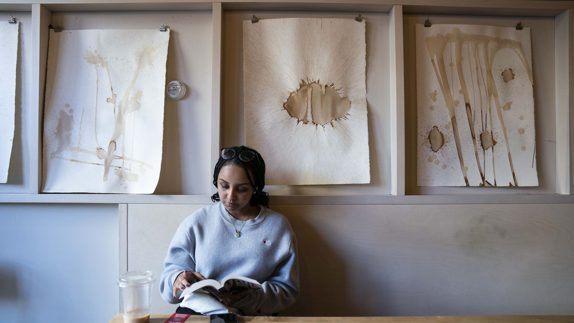 A woman Nardos Mecuria reads at The Wydown in DC. Photo by Sarah Silbiger for The Washington Post via Getty Images)