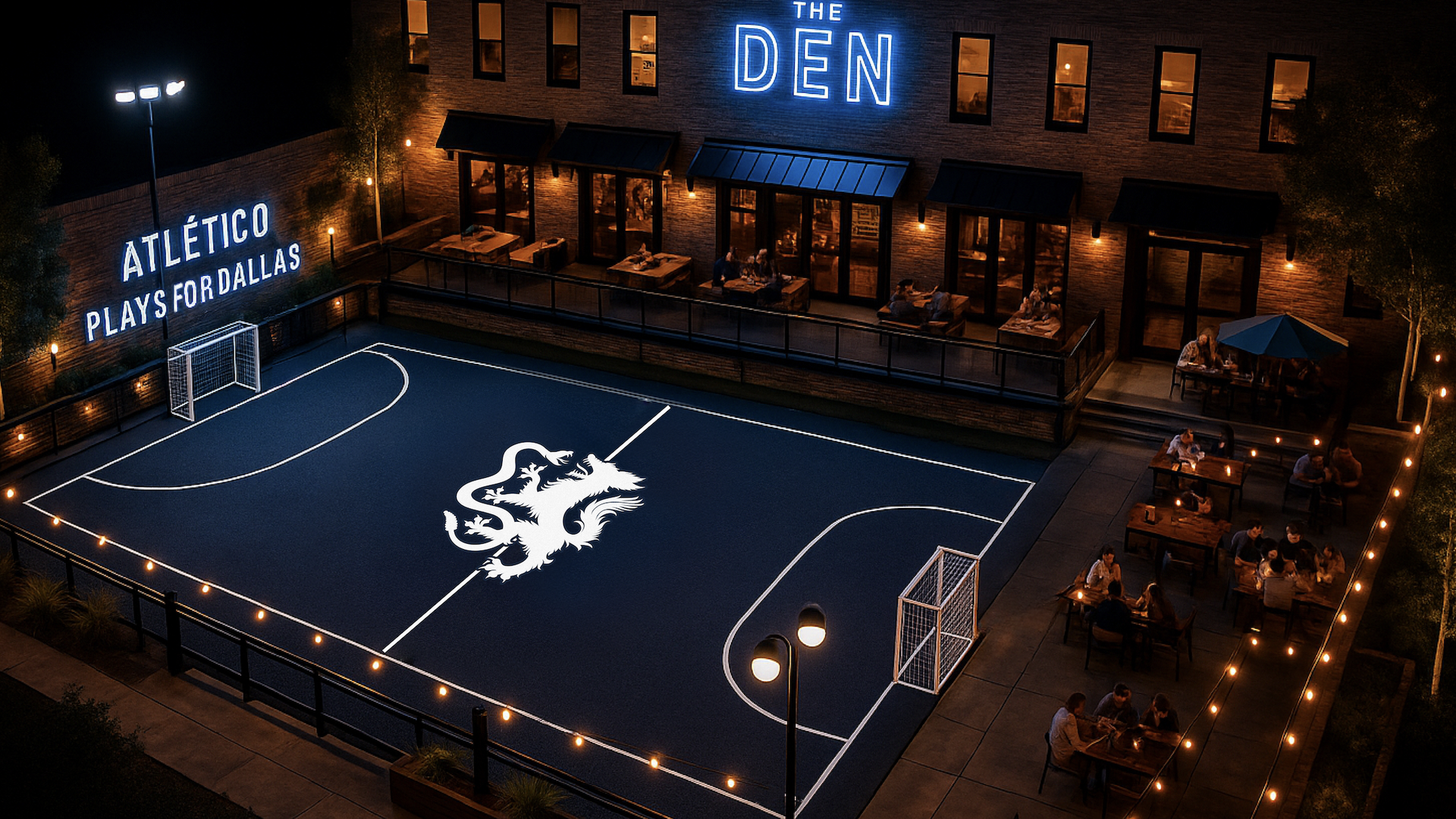 Night view of an outdoor mini soccer field with a white lion emblem at center, flanked by two goals. Neon signs say "The Den" and "Atlético Plays For Dallas". Diners sit at nearby tables.