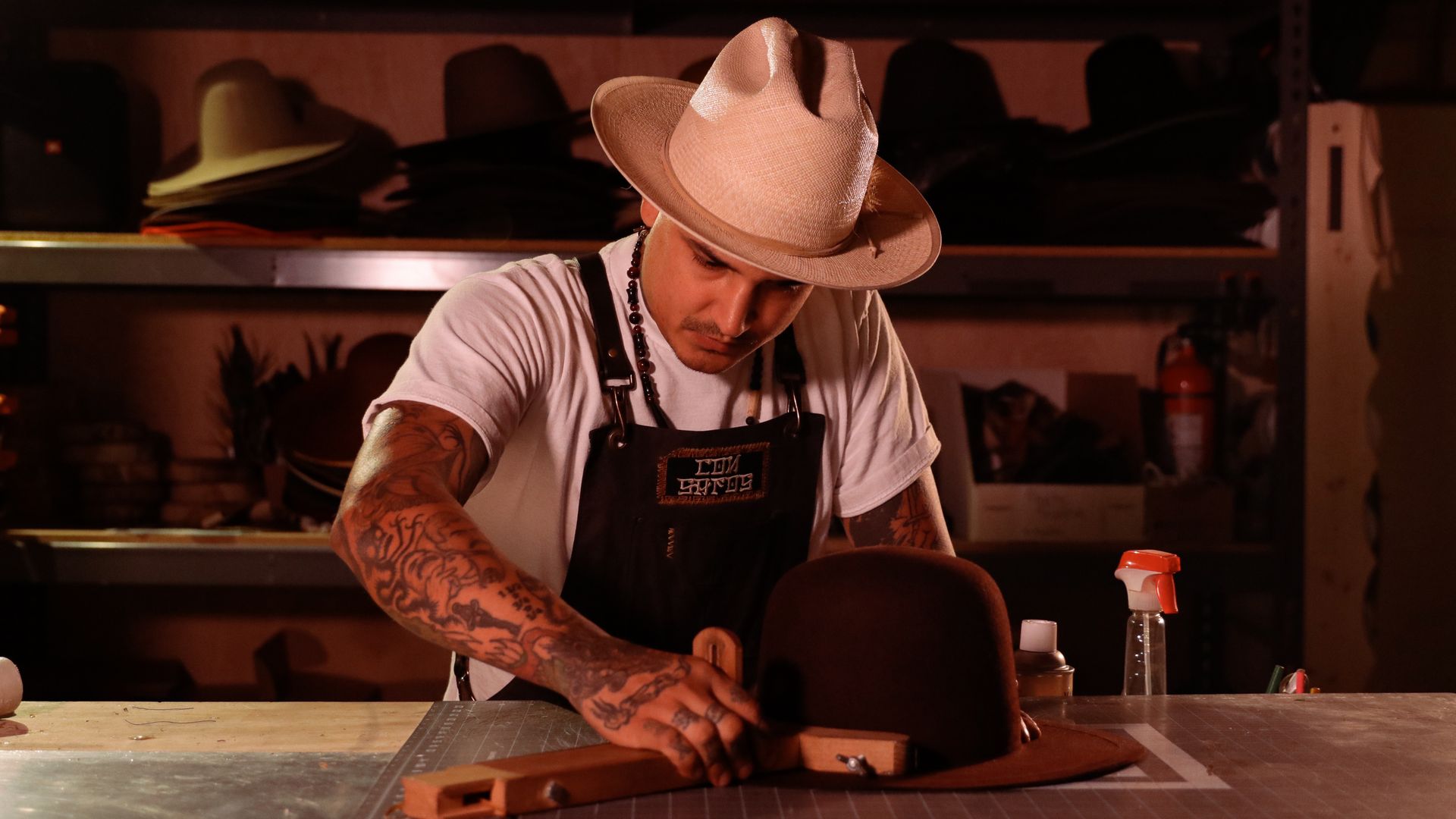 Gilbert Marquez Jr.,  founder and hatter of Pachuco Supply Company, works on making a hat in his Los Angeles shop.