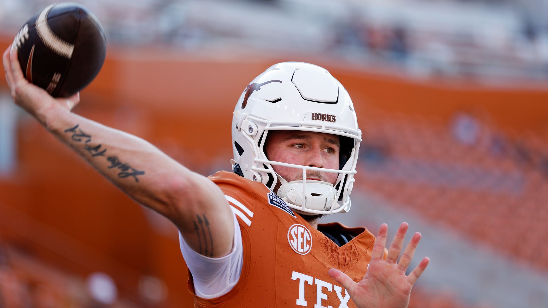 a photo of Quinn Ewers in a Texas Longhorns uniform throwing a football 