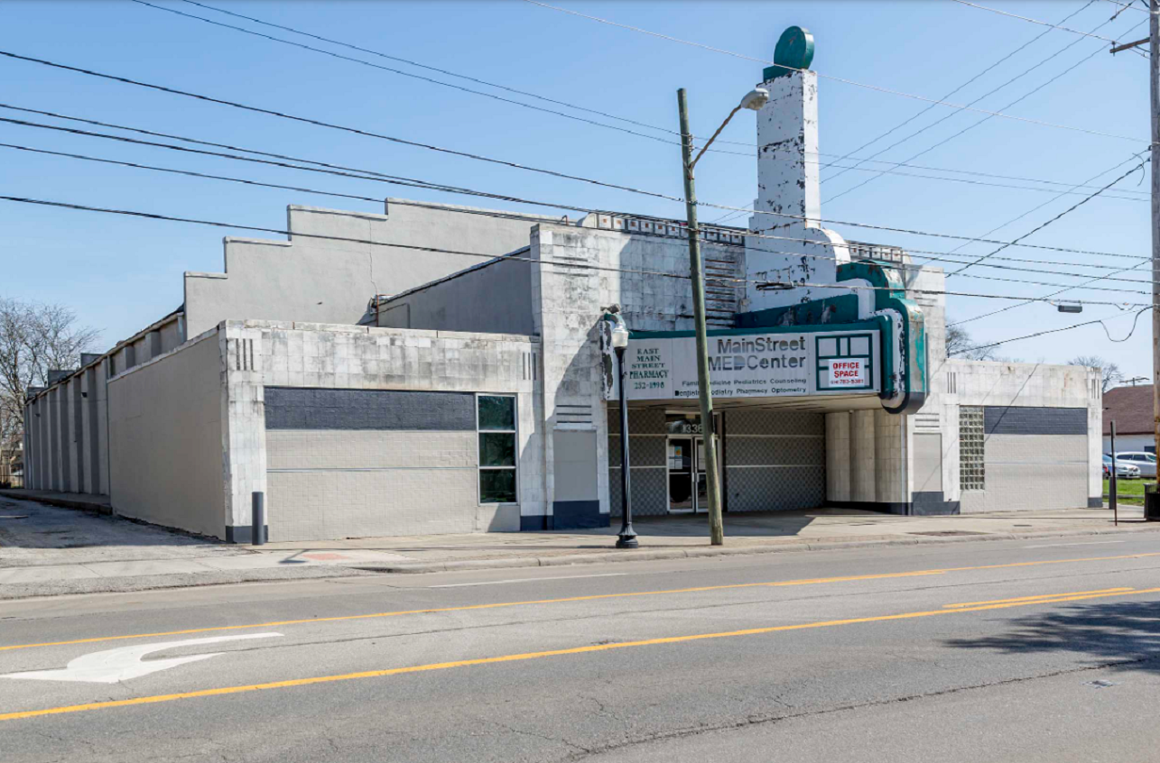 The façade and marquee of an abandoned former theatre building.