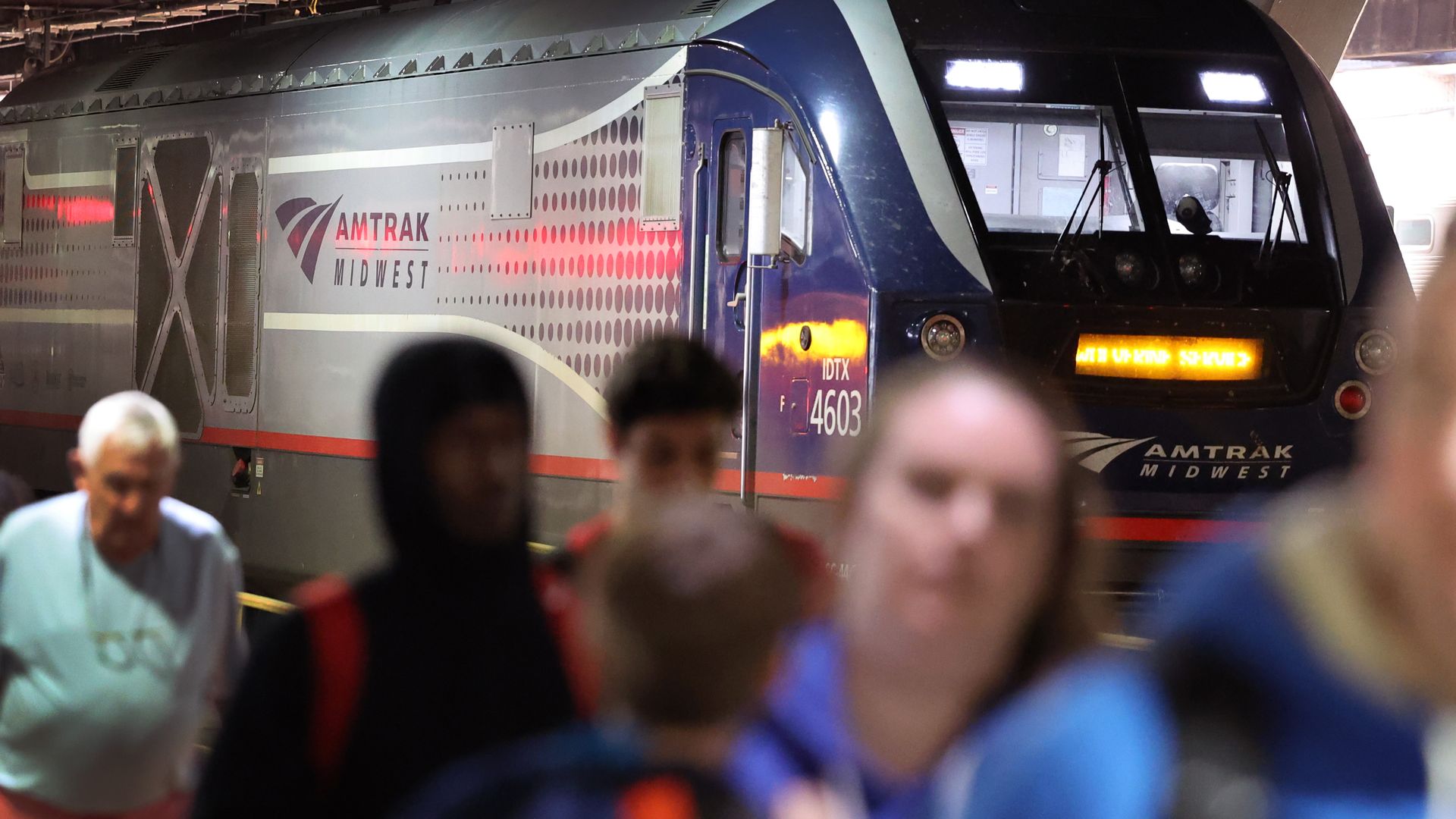 Passengers walk away from an Amtrak train inside Union Station in Chicago.