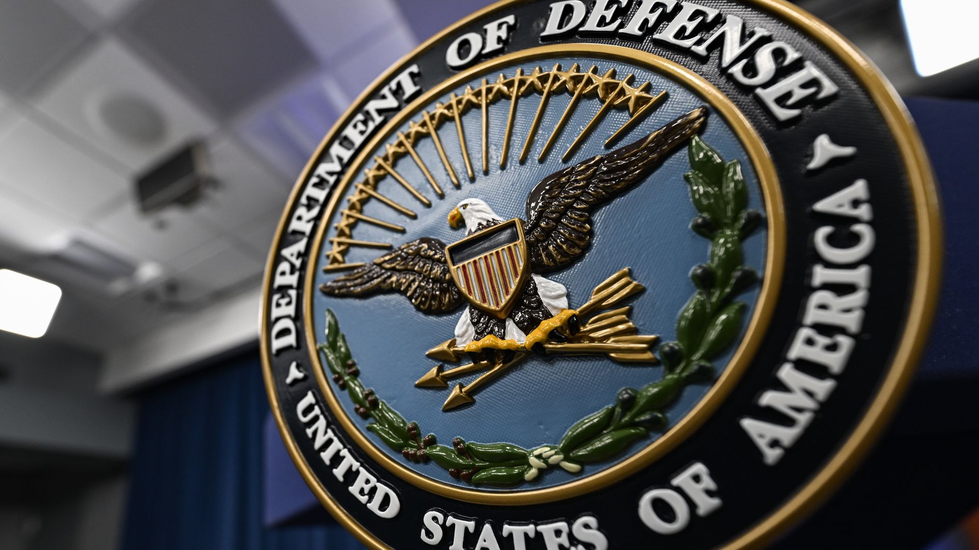 The Department of Defense seal on a podium at a press conference in August 2023.