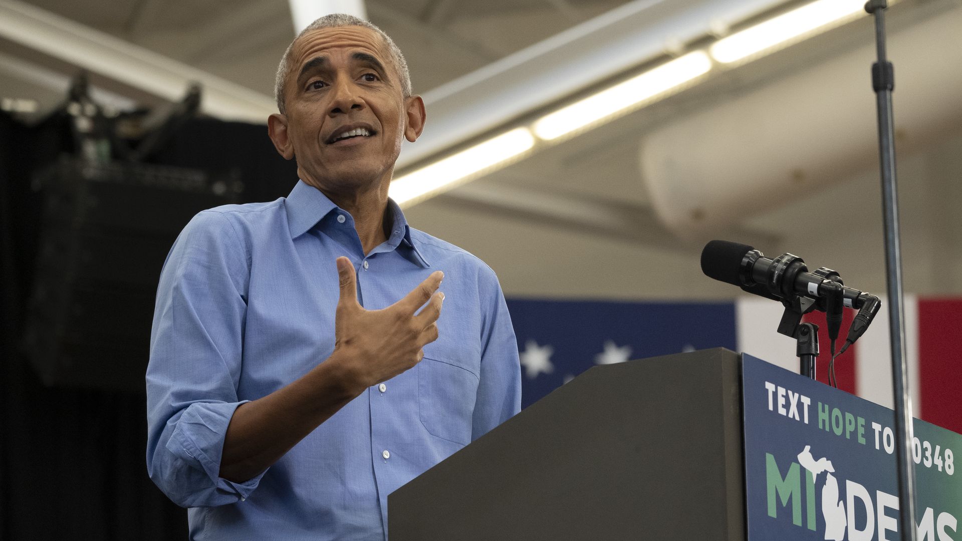 Former US President Barack Obama reacts to a heckler during a campaign rally for Michigan.