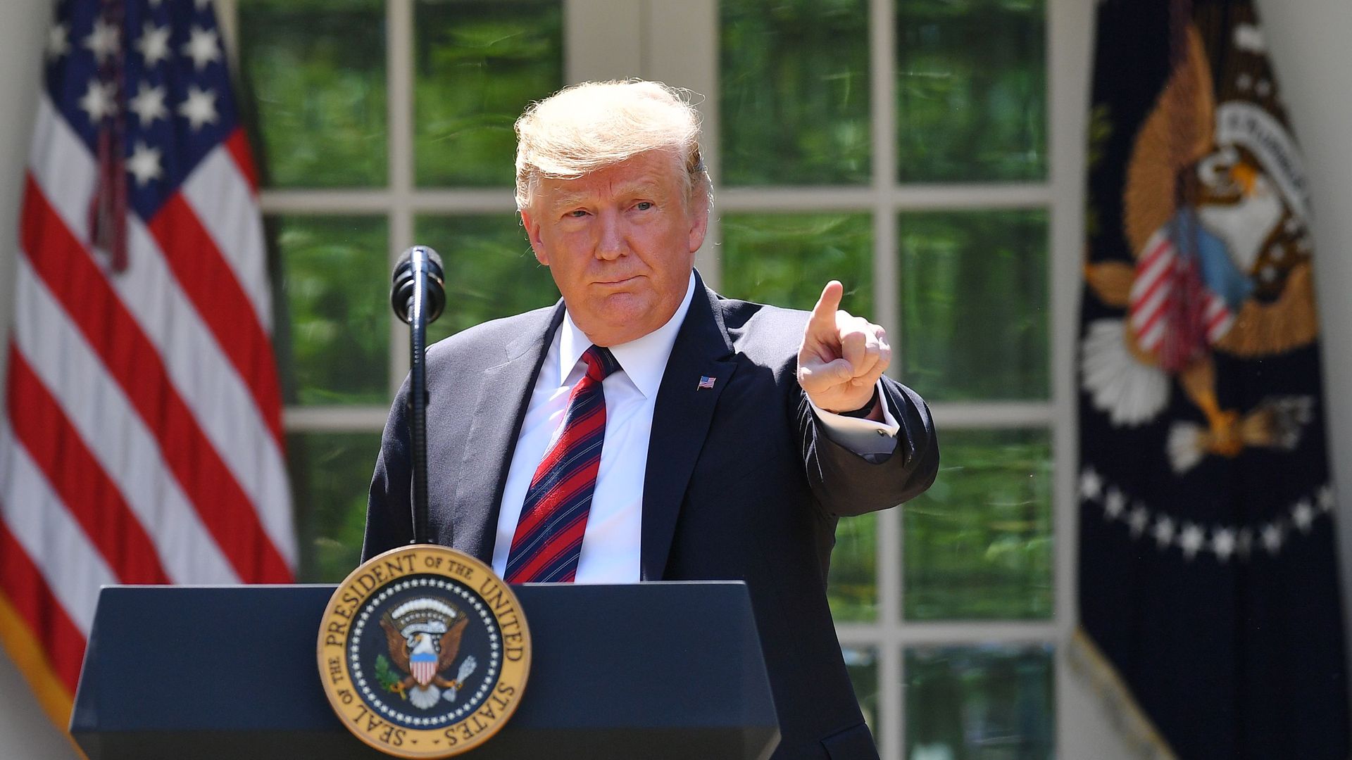 Trump points at the Rose Garden of the White House on May 16