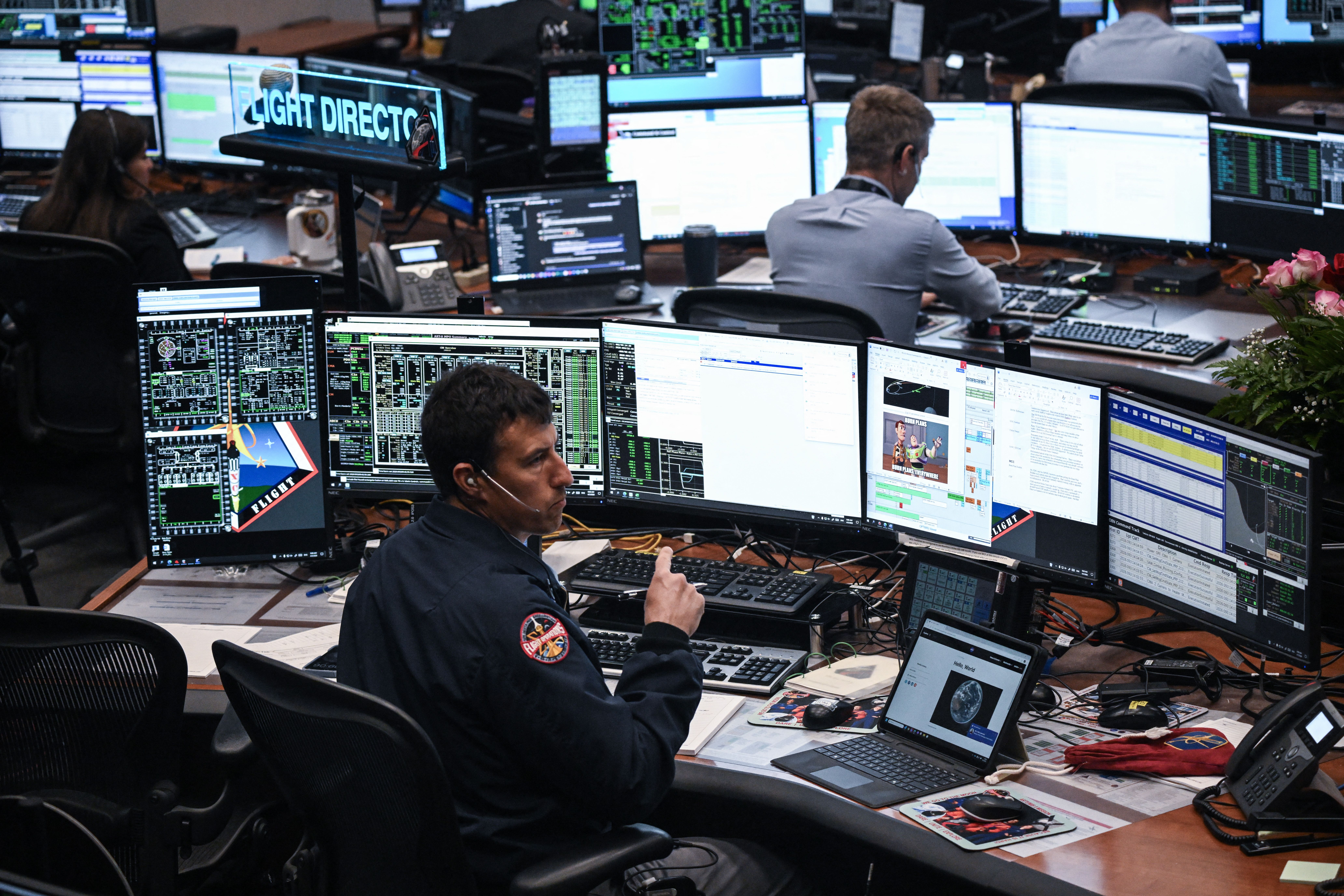 Artemis II controllers monitor the progress of the Orion spacecraft in the White Flight Control Room at Johnson Space Center in Houston, Texas, on April 3, 2026. Four Artemis astronauts were zooming towards the Moon late April 2 after a major engine firing, a milestone that commits NASA to the first