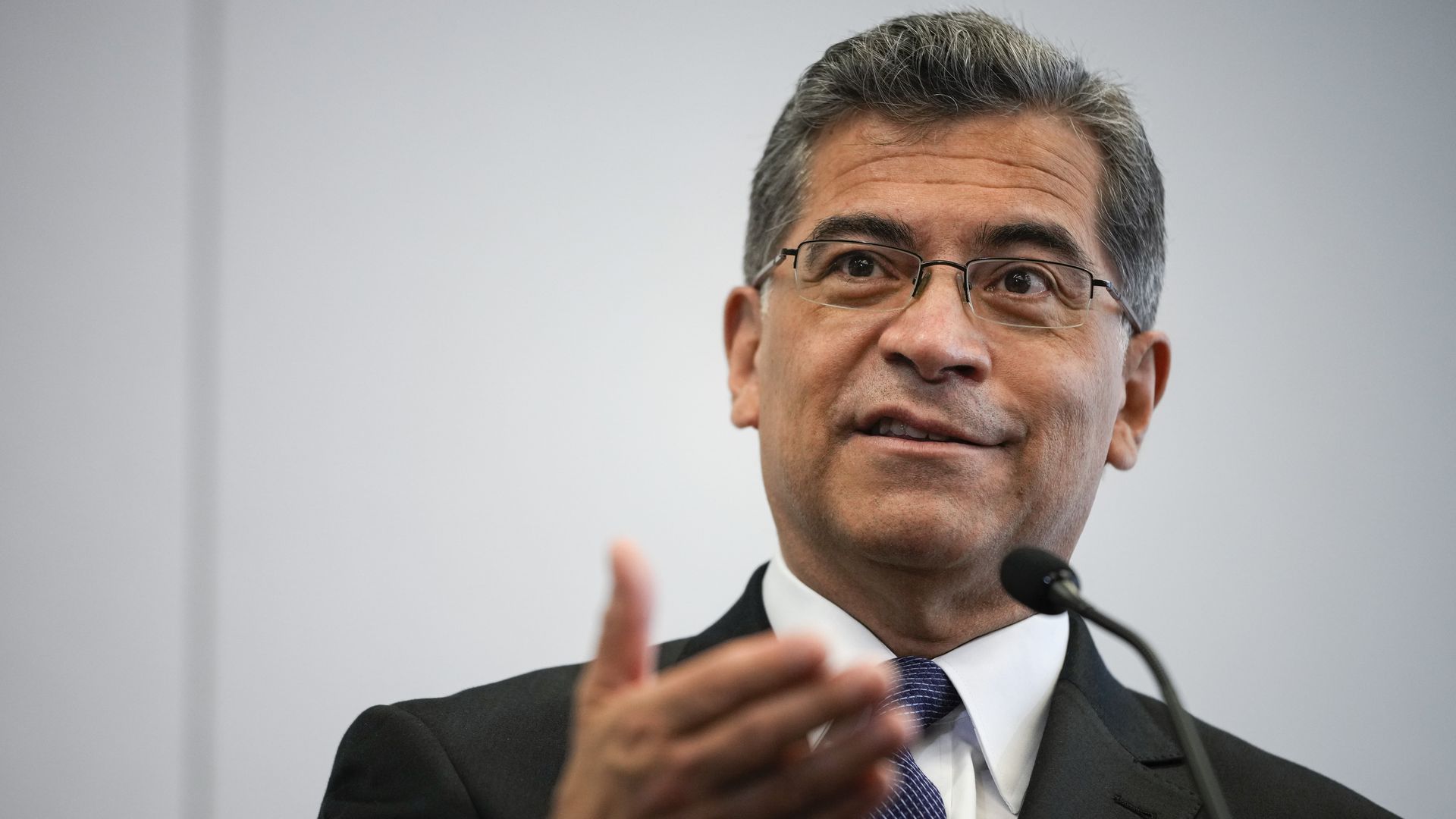 Xavier Becerra speaks into a microphone
