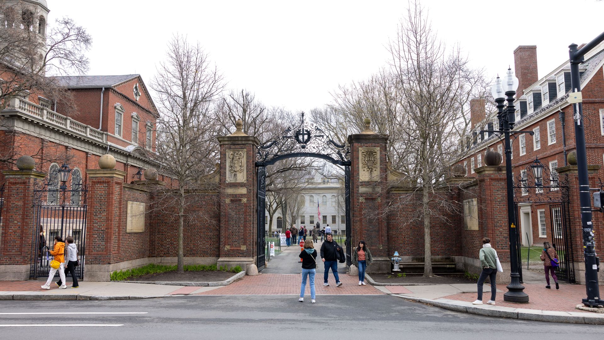 Tourists in front of the main gate to Harvard Yard on April 15, 2025 in Cambridge, Massachusetts. A Trump administration task force announced Monday that it would block Harvard University from receiving $2.2 billion in federal grants and $60 million in contracts after the Ivy League school defied de
