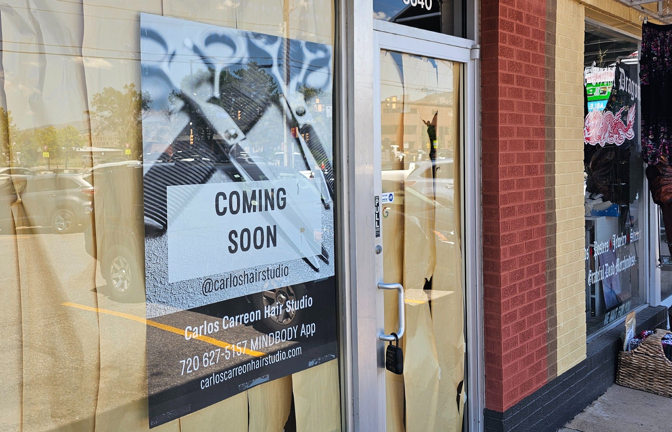 A sign that says "Coming Soon" for a new Carlos Carreon Hair Studio in Boulder