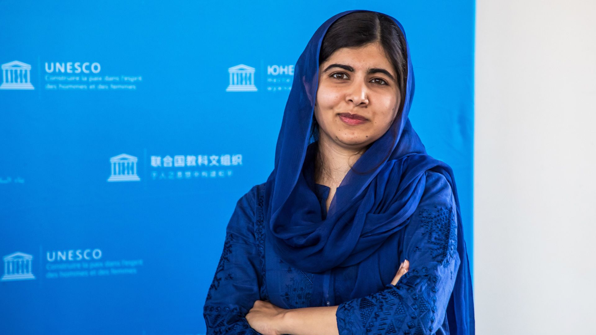 Malala Yousfazi standing with her arms crossed