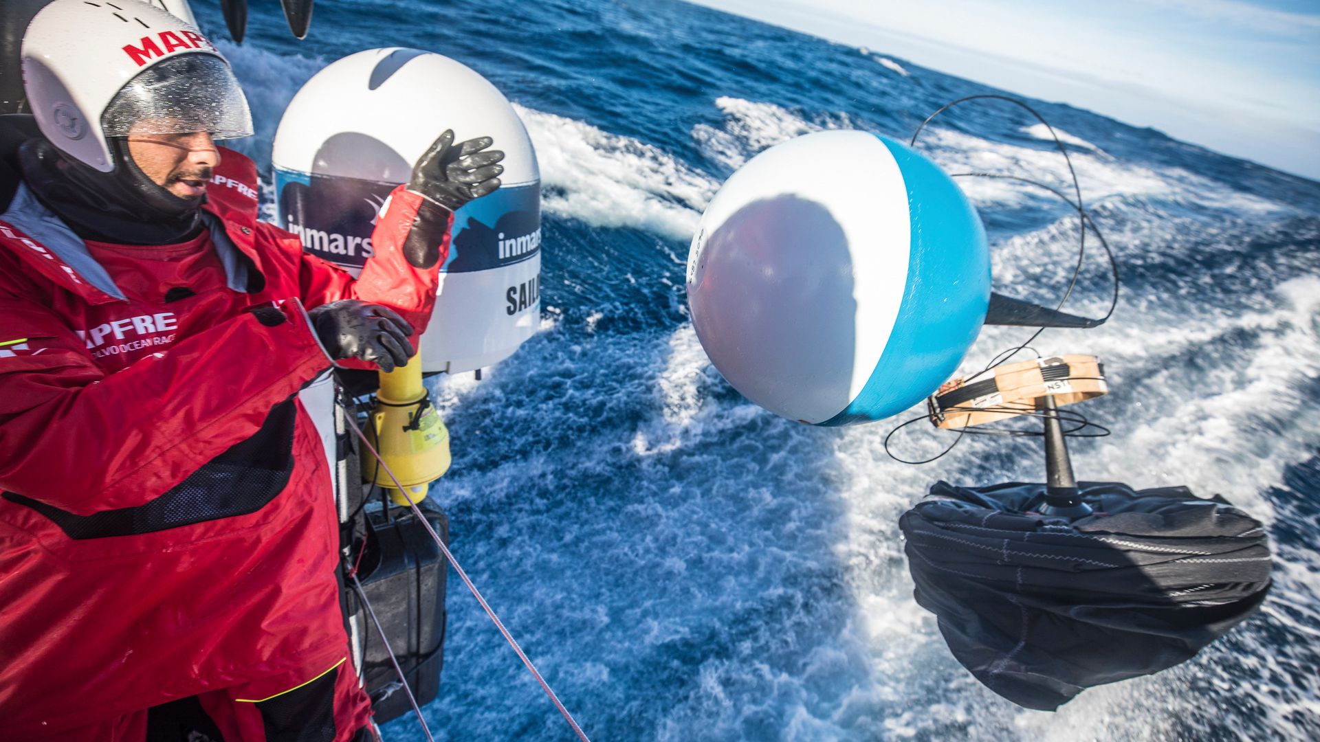 A sailor taking part in the Volvo Ocean Race deploys an instrument to detect microplastics. 