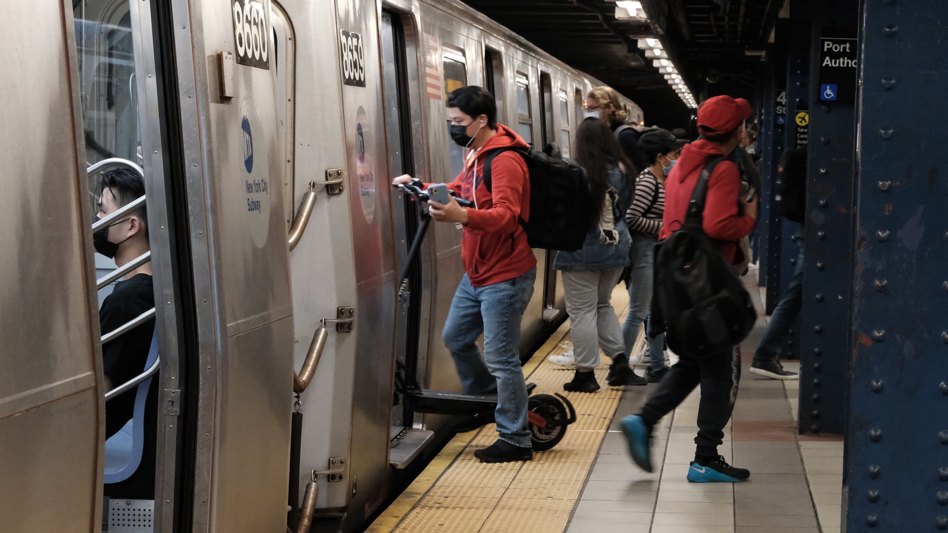 Passengers boarding a NYC subway train