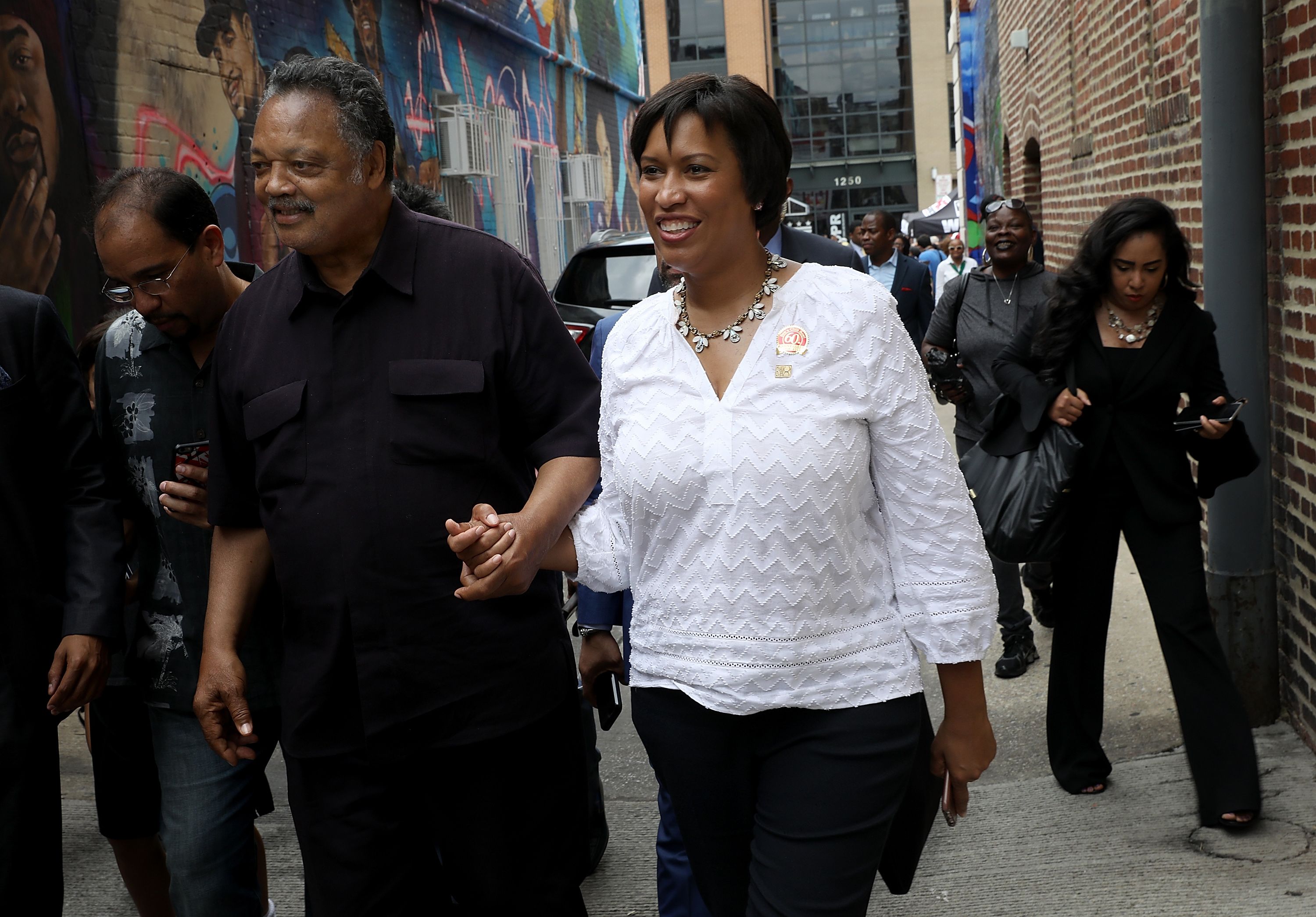 Jesse Jackson next to Mayor Muriel Bowser outside Ben's Chili Bowl for its 60th anniversary in 2018