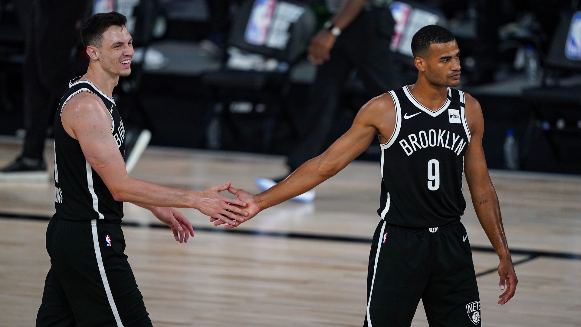 NBA players high-fiving.