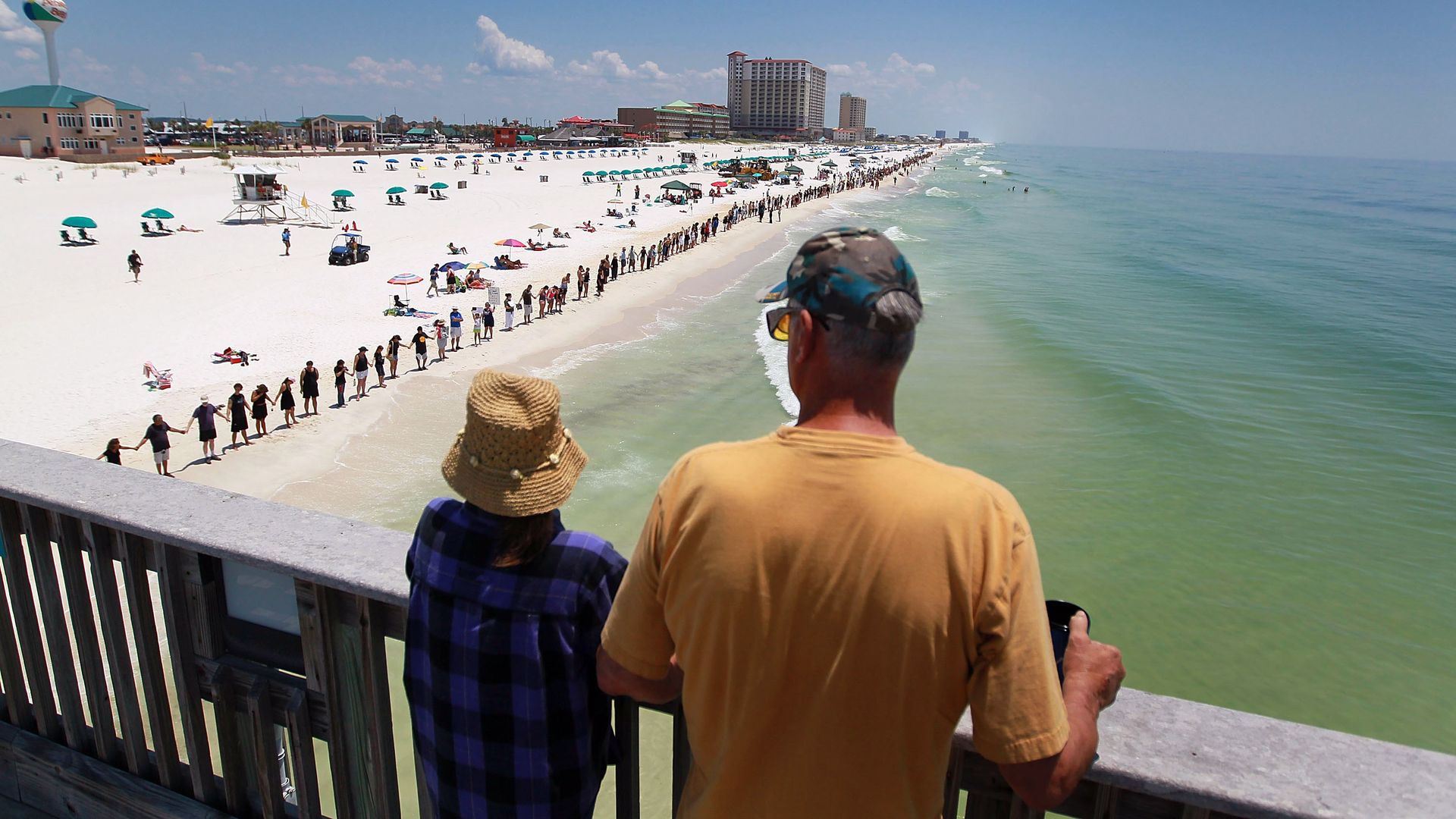 Line of people stretches across Pensacola beach in the June 2010 Hands Across the Sand protest against Deepwater Horizon oil spill