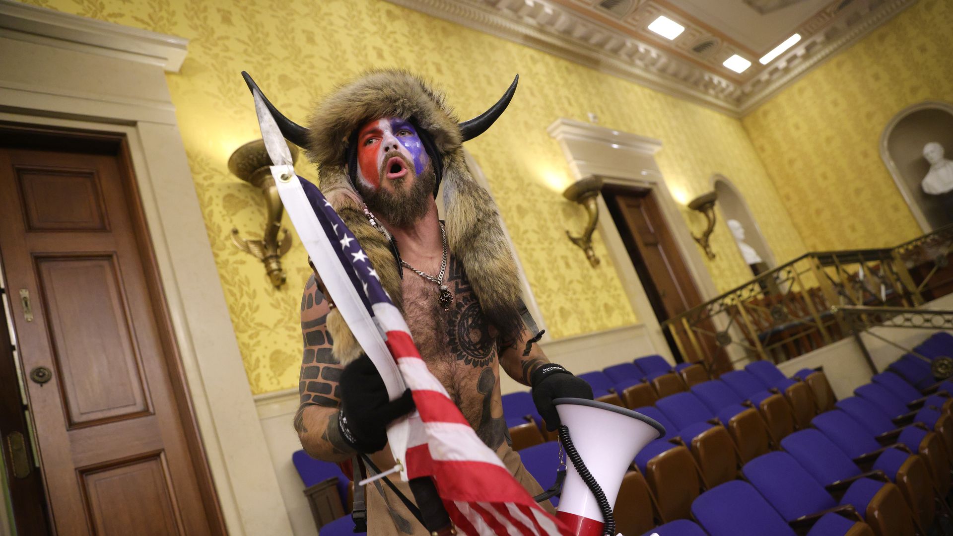 A protester screams "Freedom" inside the Senate chamber after the U.S. Capitol was breached by a mob during a joint session of Congress 
