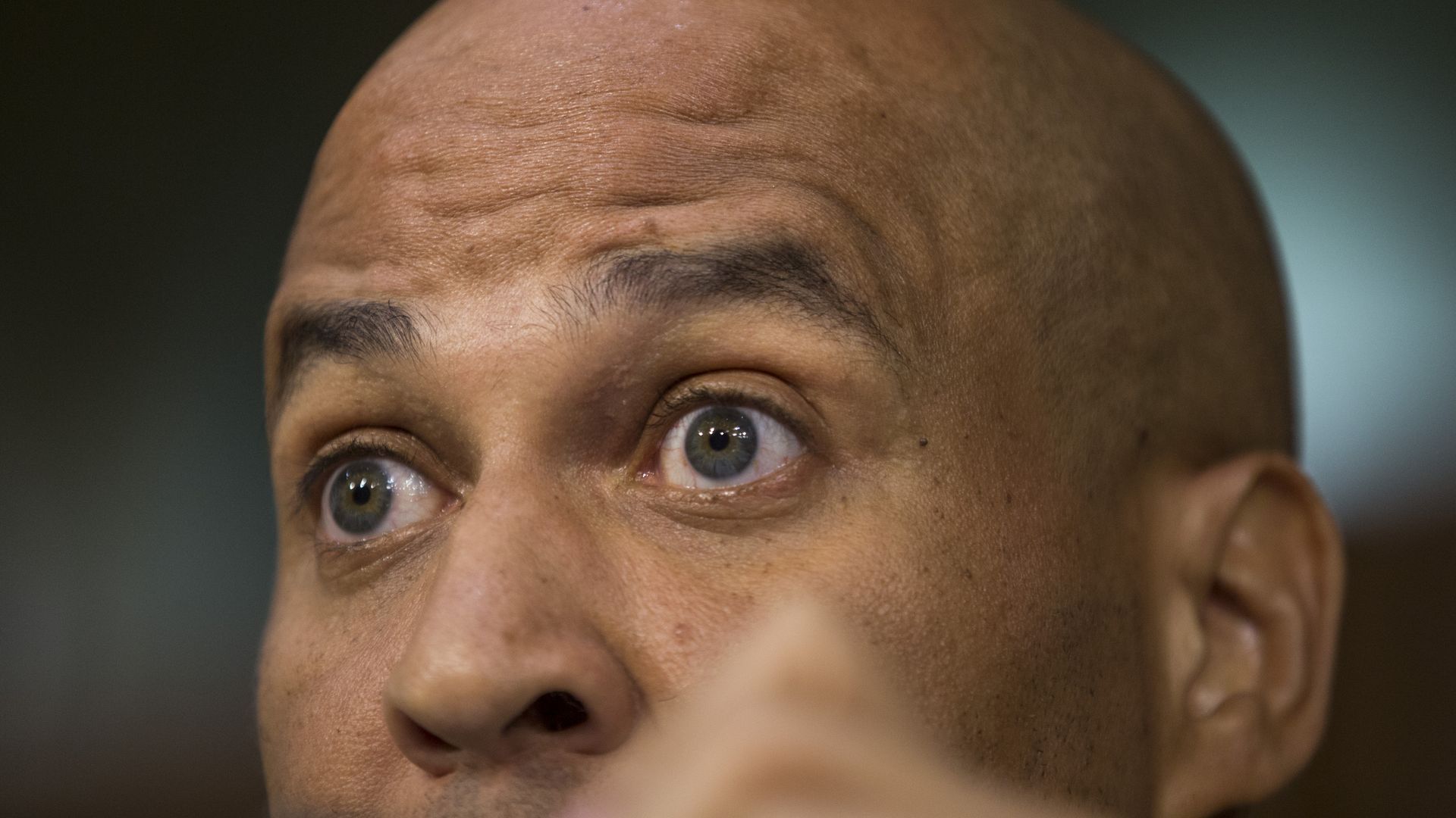 A close up of Cory Bookers wide-open eyes and bald head. His lips are cut off from the photo.