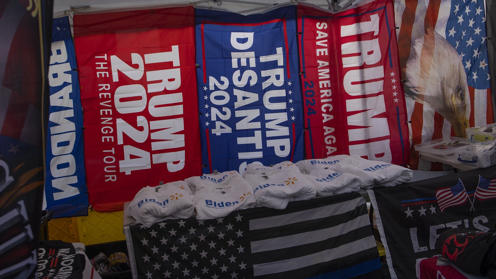 Banners for former President Donald Trump and Florida Gov. Ron DeSantis are pictured at a conservative rally.