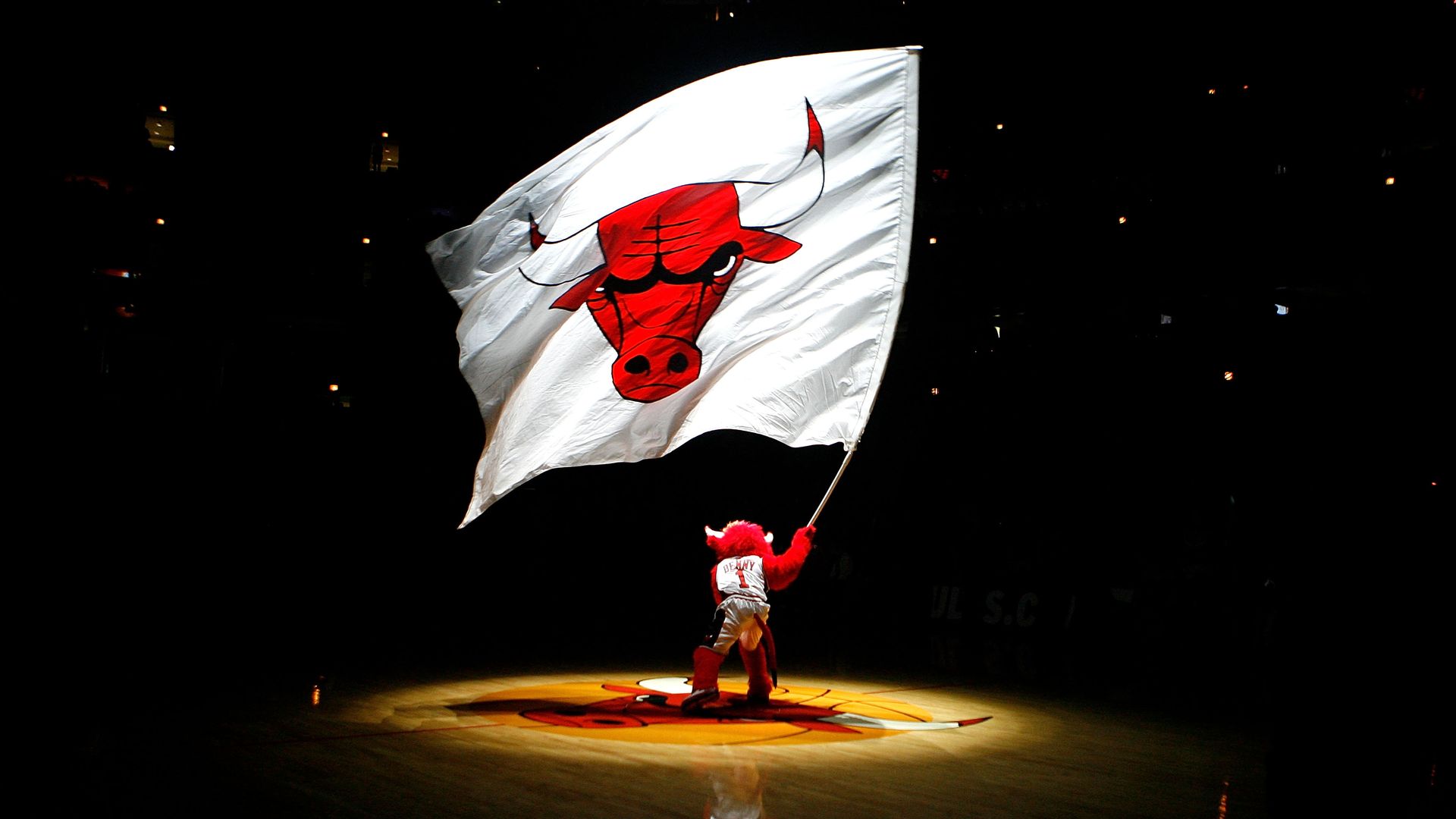 Photo of a basketball mascot waiving a Bulls flag. 