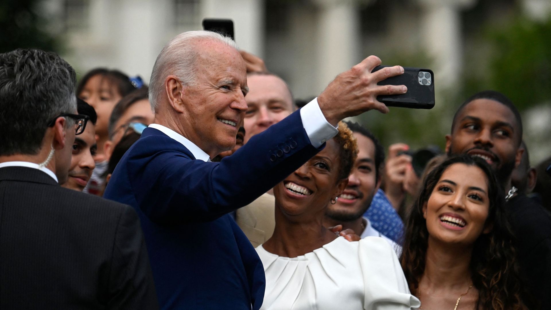 US President Joe Biden poses for a selfie with guests after delivering a speech during Independence Day celebrations on the South Lawn of the White House.