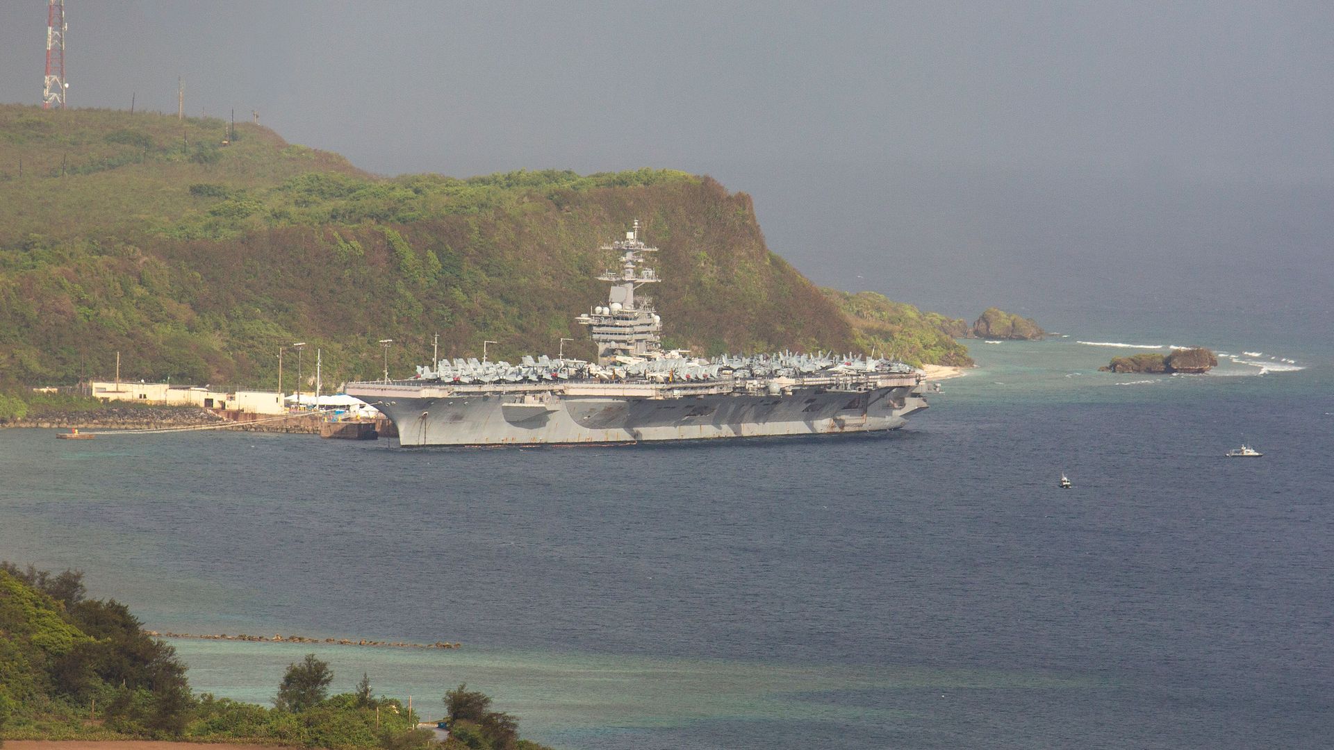The aircraft carrier USS Theodore Roosevelt, is docked at Naval Base Guam in Apra Harbor amid the coronavirus pandemic on Monday, April 27, 2020. 