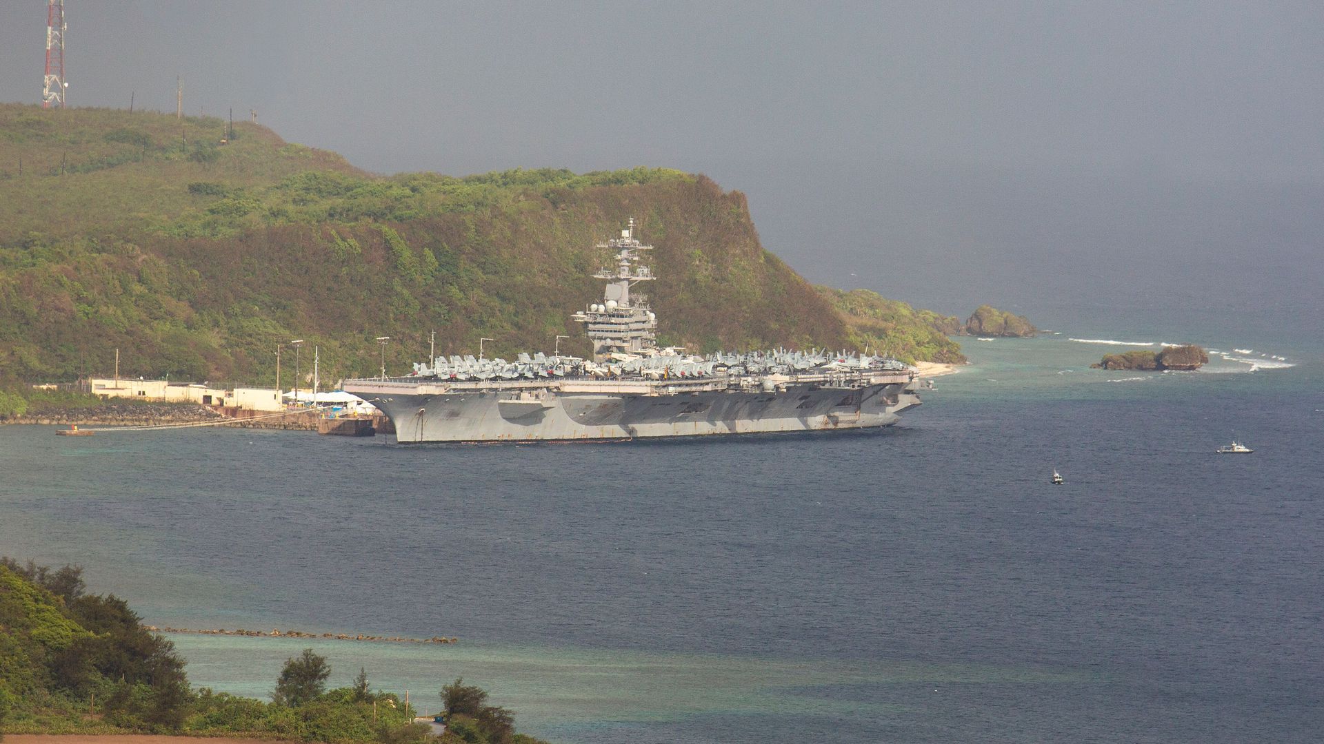 The aircraft carrier USS Theodore Roosevelt, is docked at Naval Base Guam in Apra Harbor amid the coronavirus pandemic on Monday, April 27, 2020.