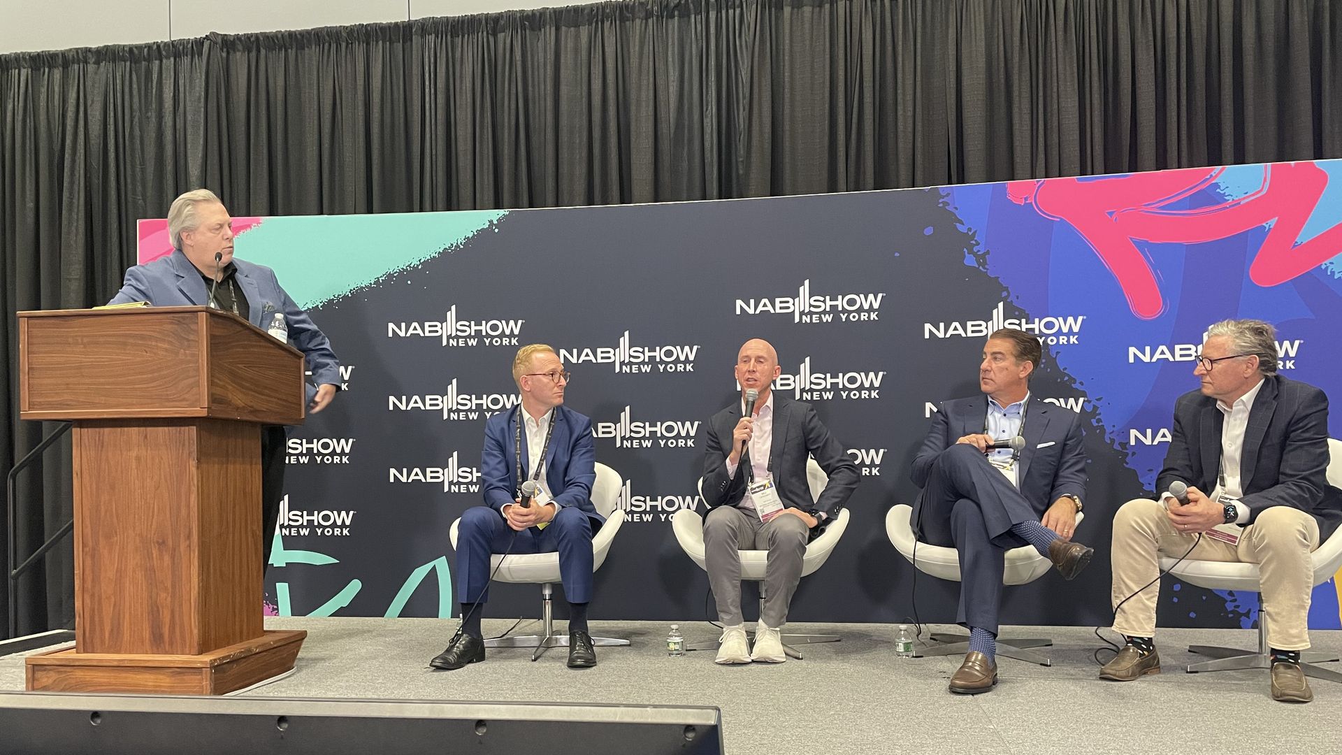 A panel of sports media executives on stage