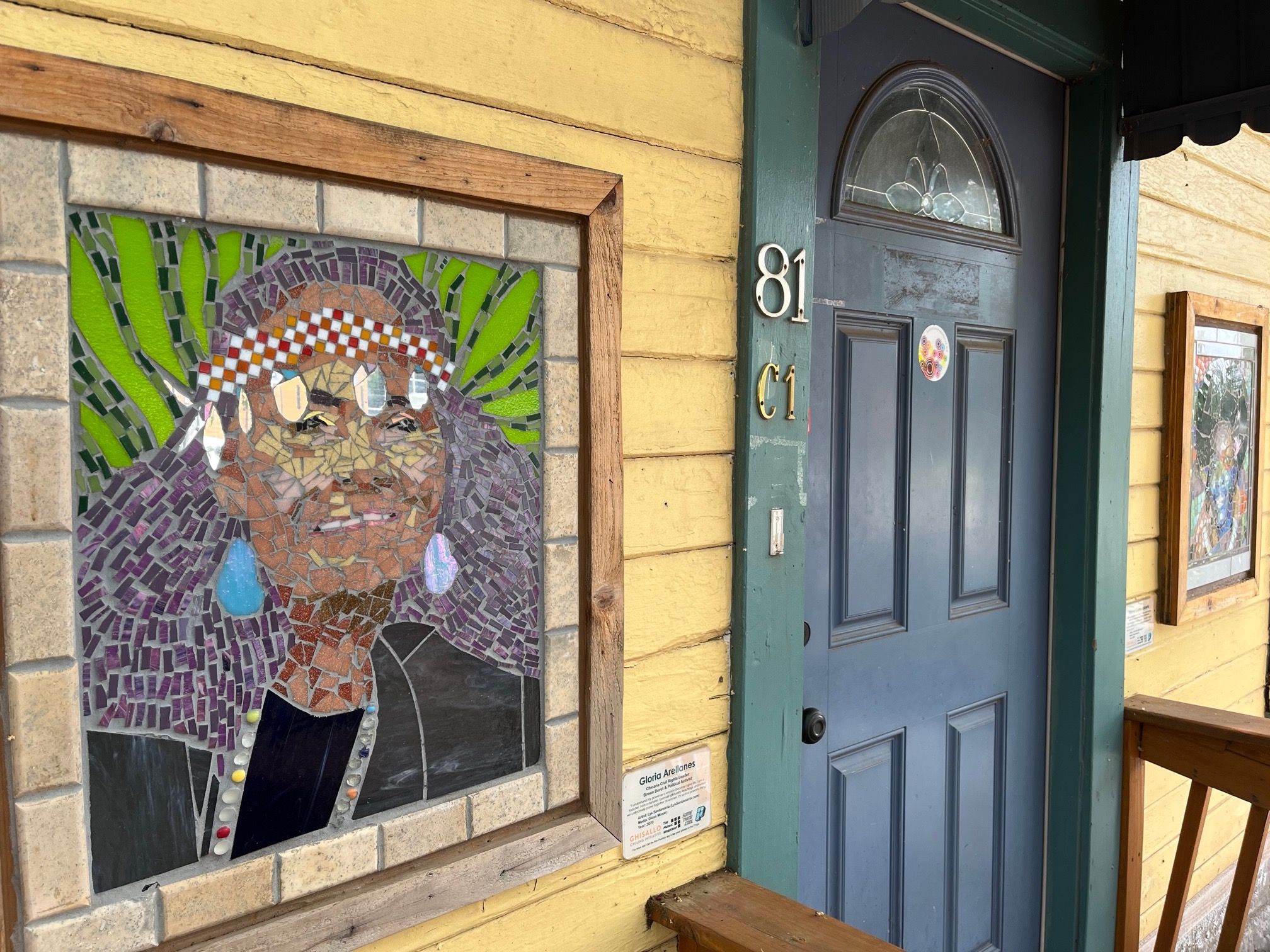Mosaic portraits flank a door to the property.