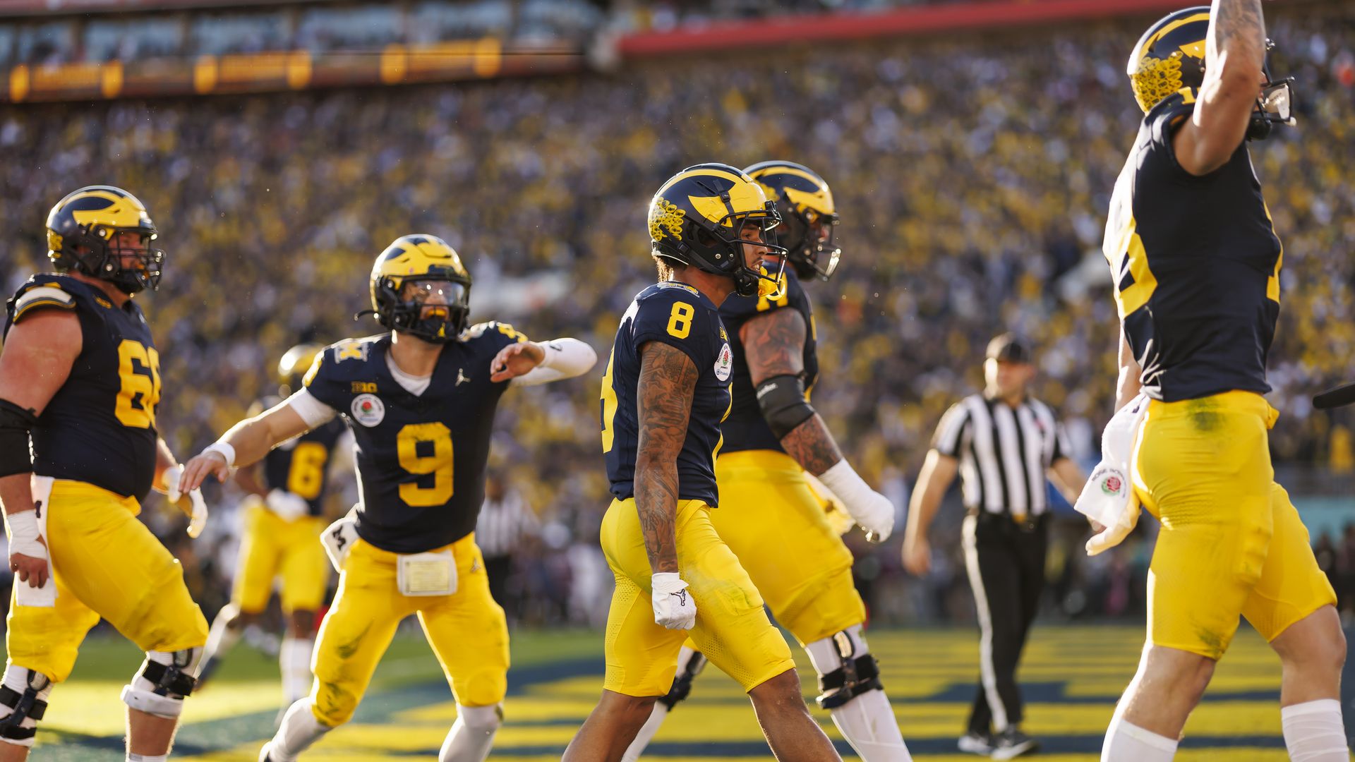 Michigan Wolverines celebrates with the team after scoring a touchdown during the CFP Semifinal Rose Bowl Game