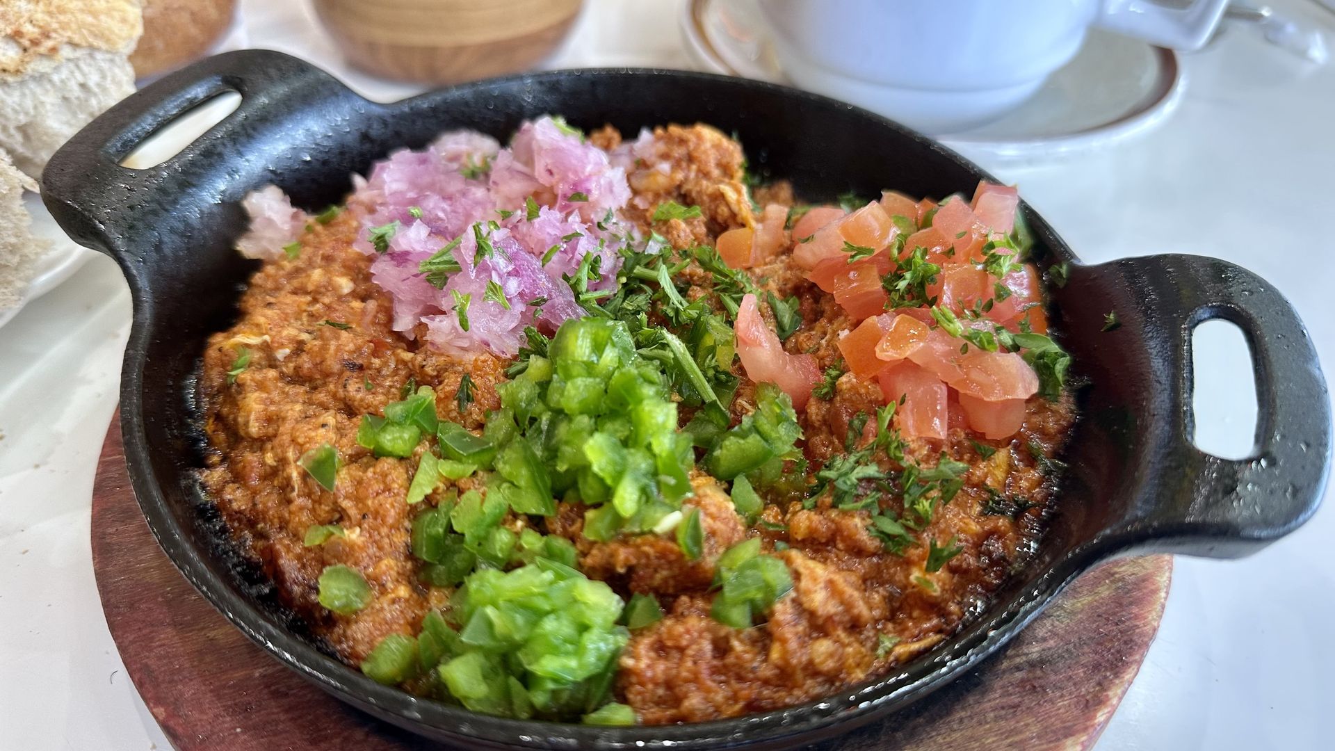 Ethiopian silsi served with scrambled eggs, onions, tomatoes and cilantro