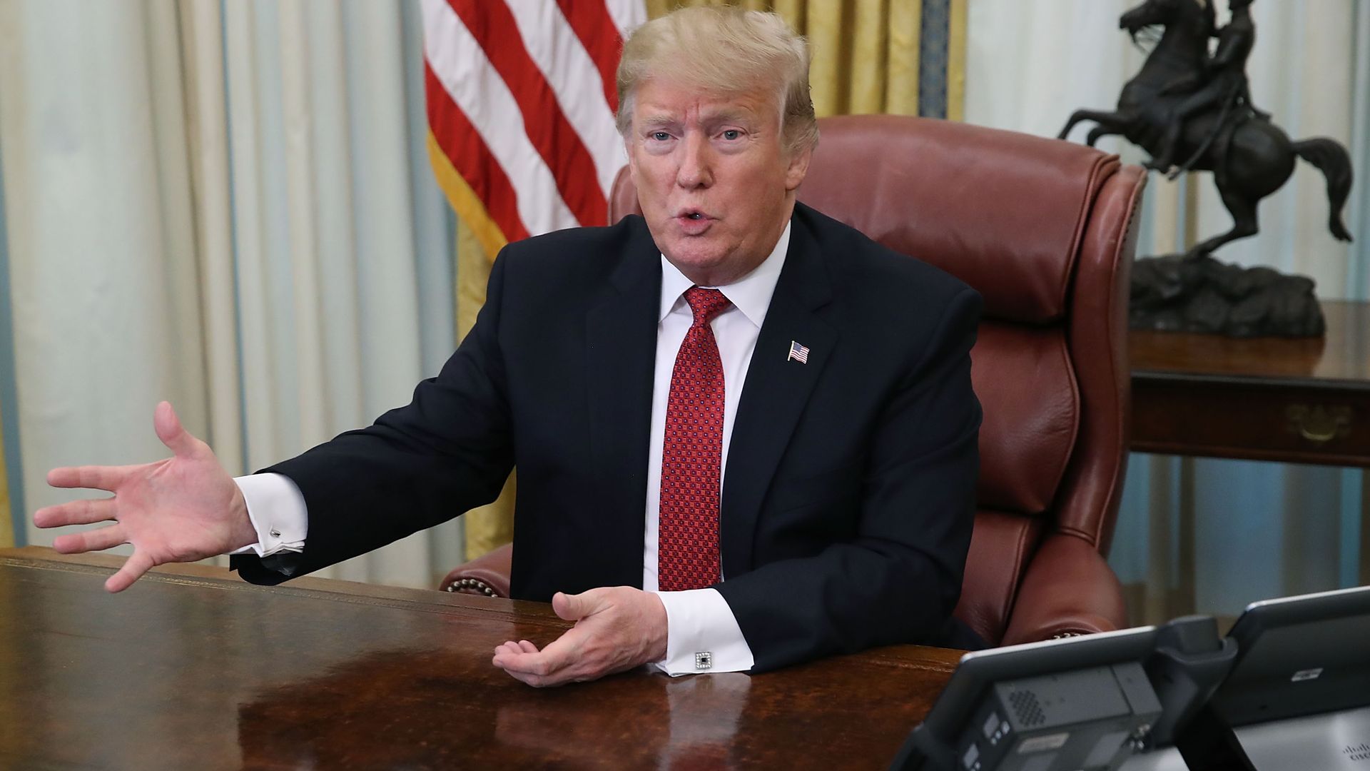 President Trump sitting at a desk