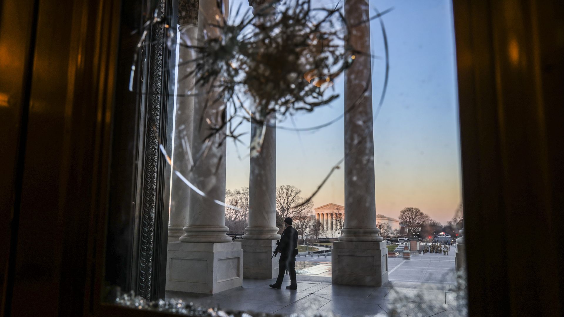 The Supreme Court is seen through a window broken in last week's assault on the U.S. Capitol.
