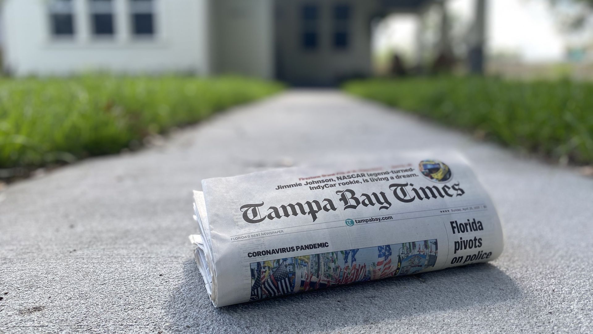 A photo of the Tampa Bay Times on a sidewalk in front of a home.