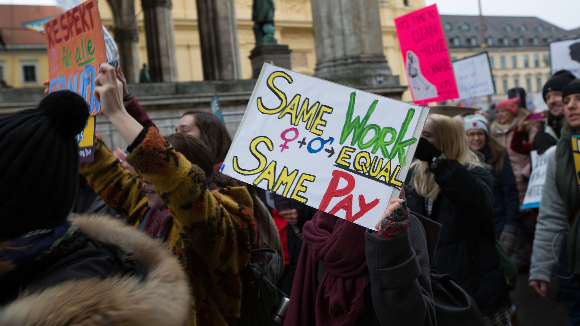 Woman hold a banner for equal pay during the women's march against against US-president Donald Trump's sexism in Munich, Germany, on 20 January 2018.