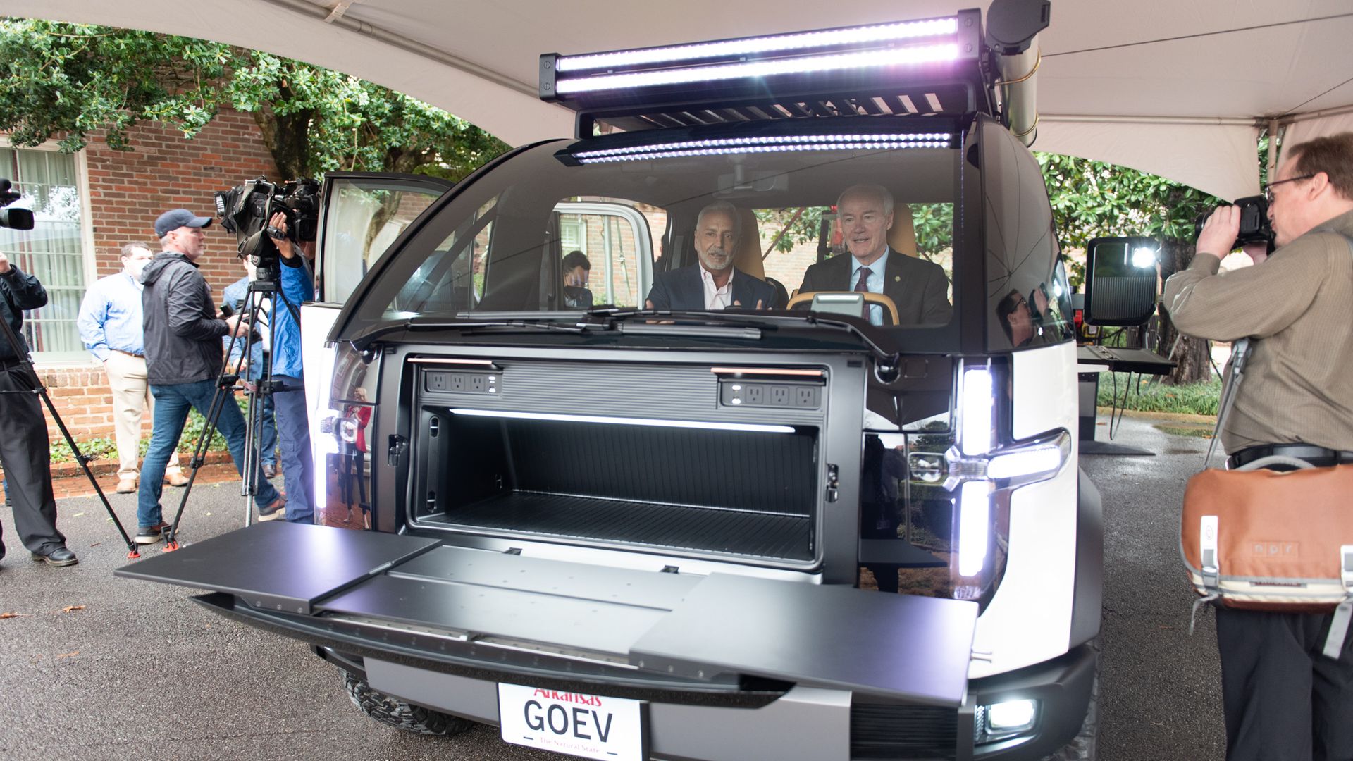 Canoo CEO, Tony Aquila shows Gov. Asa Hutchinson a prototype at an event announcing the Arkansas Council Future Mobility.