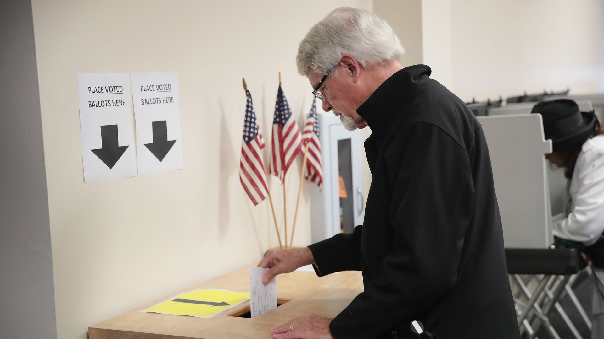 An Iowa voter casts an early ballot