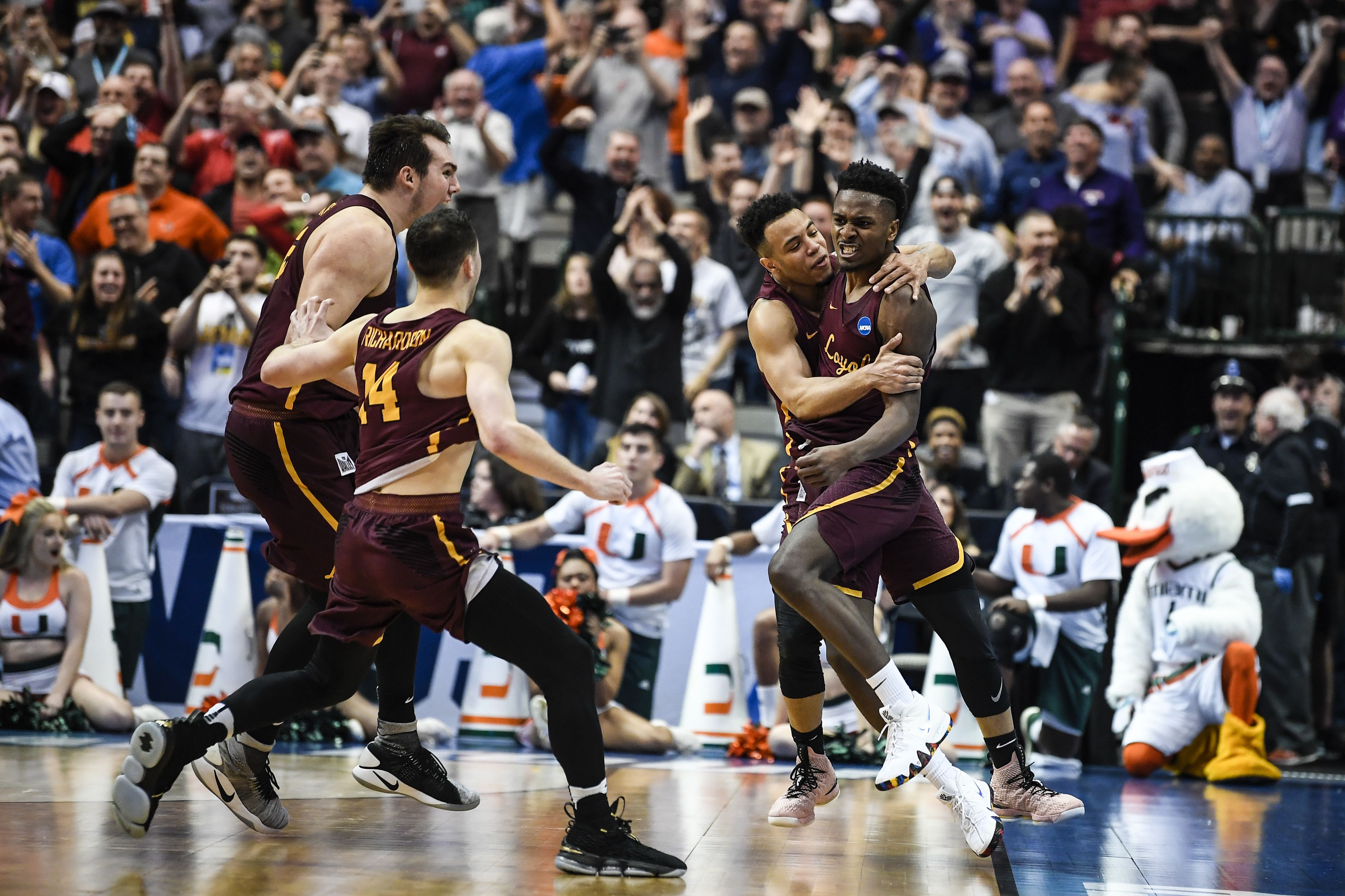 Photo of basketball players celebrating after winning. 