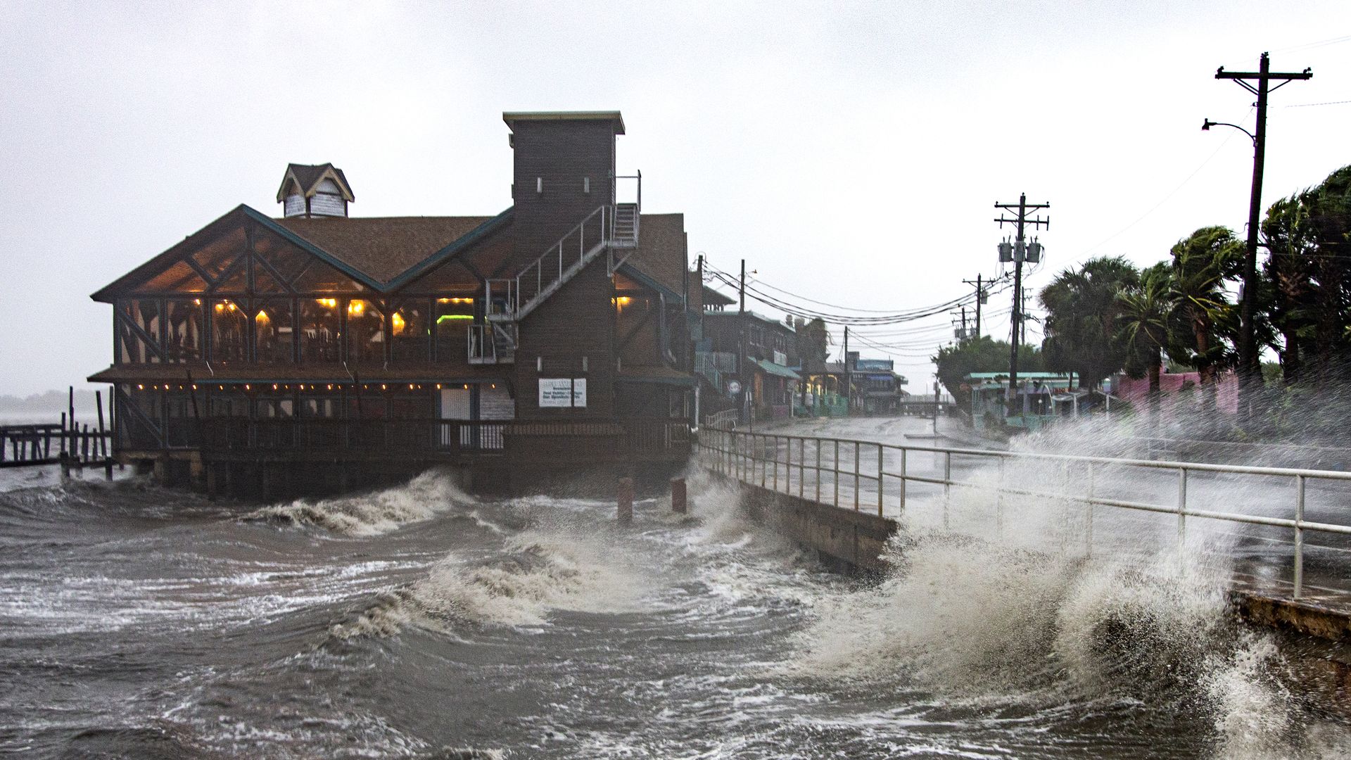 Churning storm waves batter the side of a canal in Florida