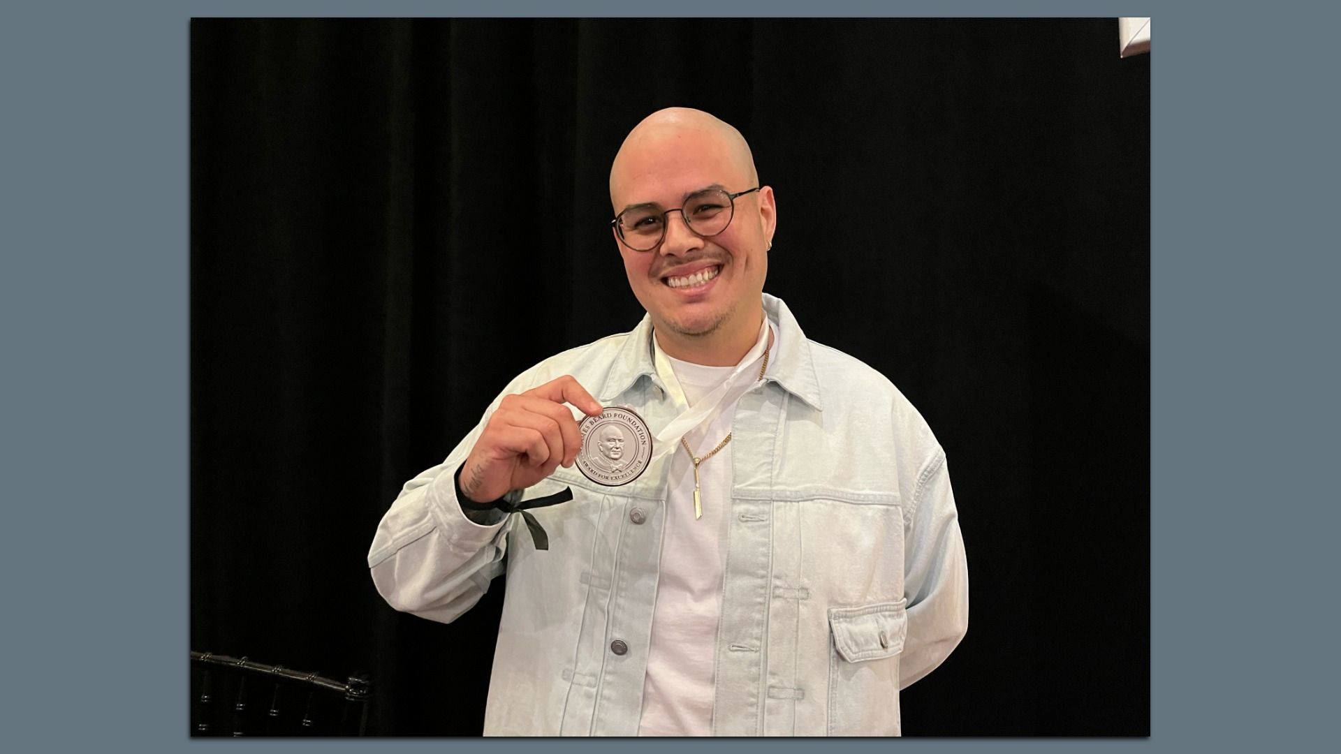 Nando Chang posing after winning his James Beard Award. 