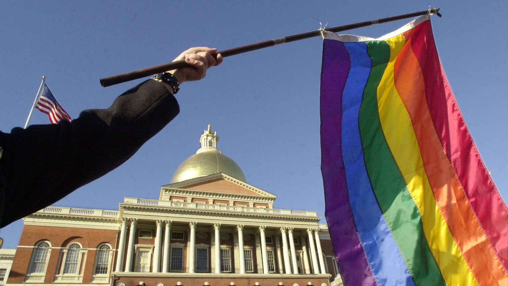 A supporter of gay marriage waves a rainbow flag outside the Massachusetts State House, 