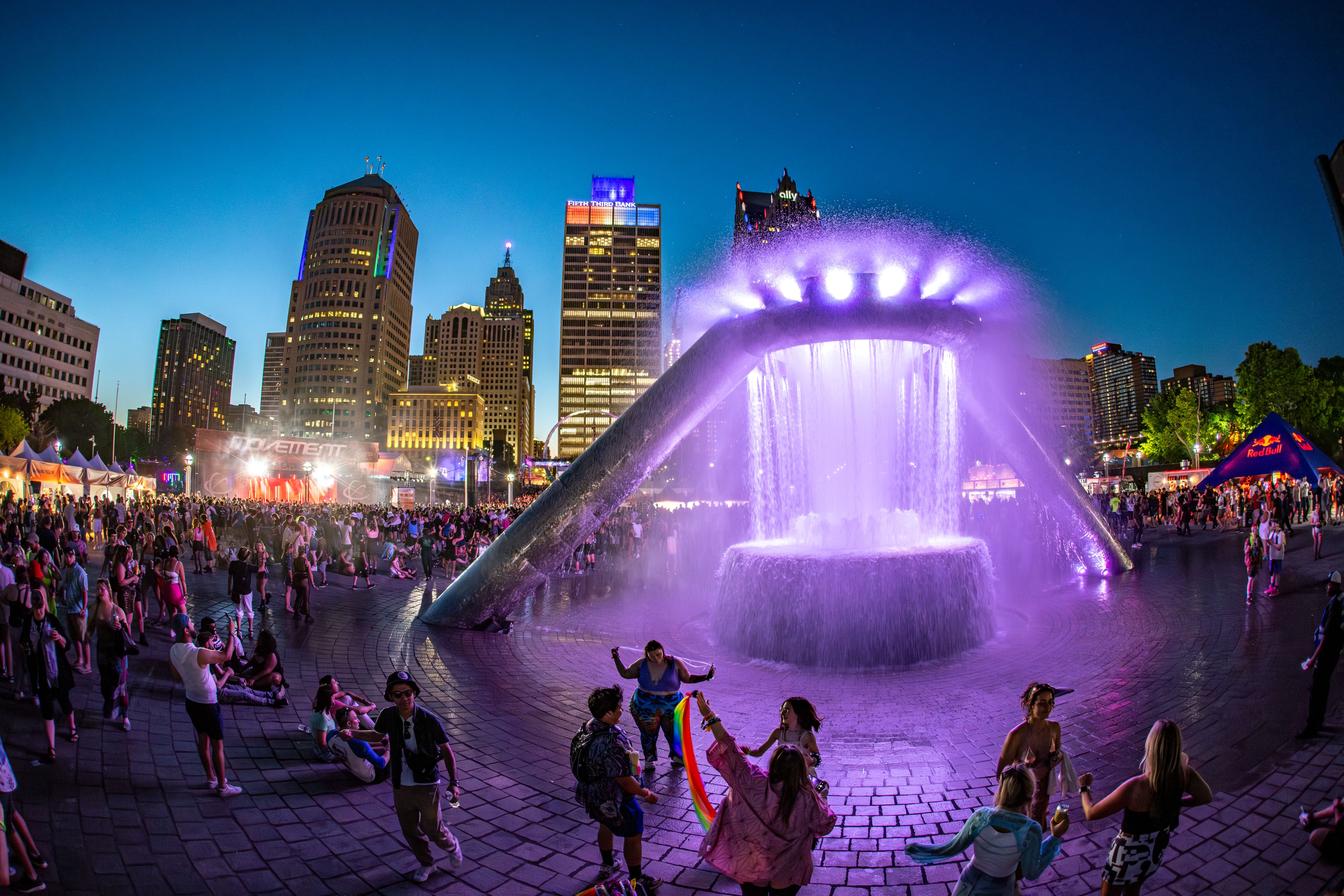 Patrons dance at movement with flags and neon lights
