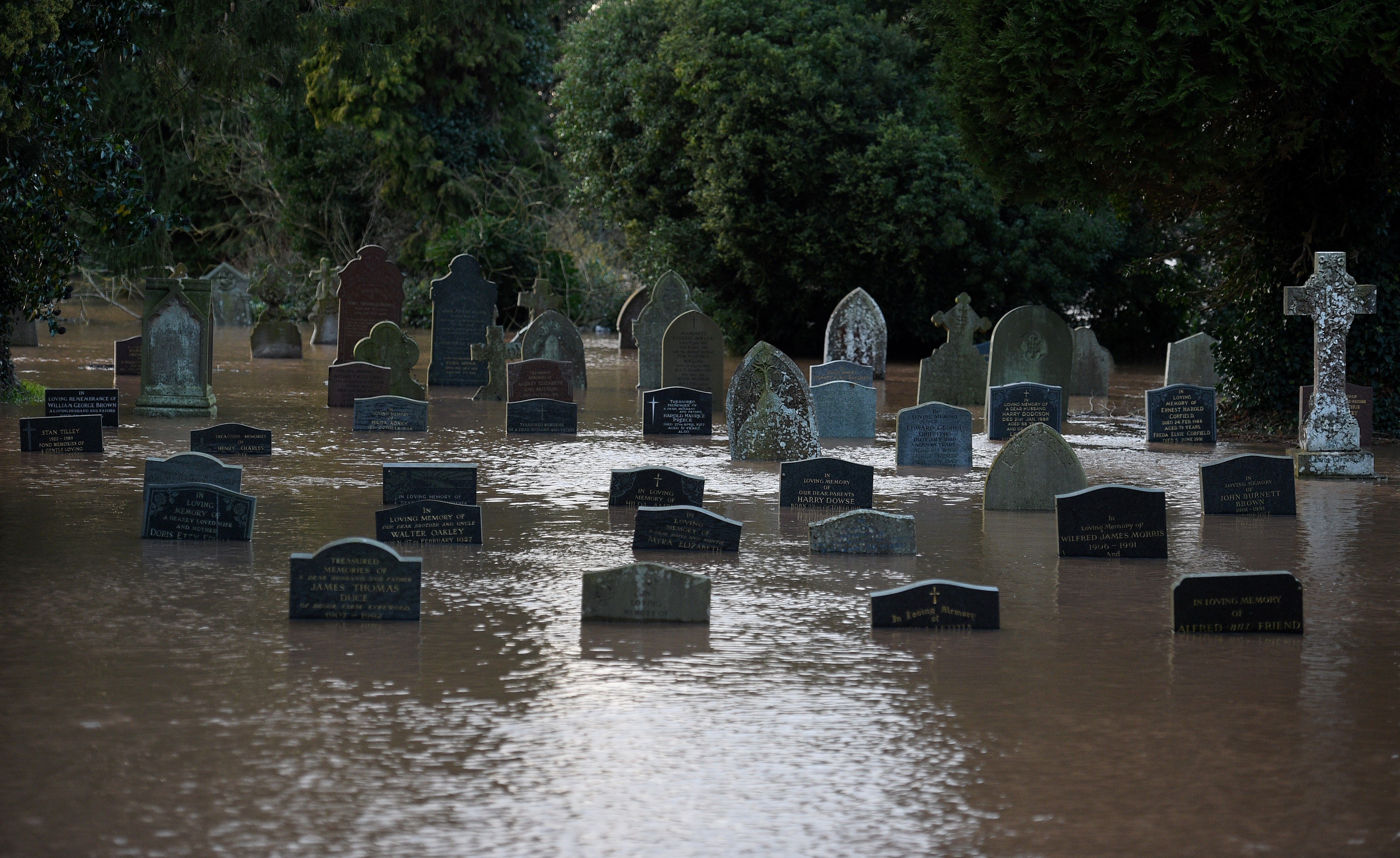  Flood water surrounds grave stones in a graveyard in Tenbury Wells, after the River Teme burst its banks in western England, on February 16, 2020