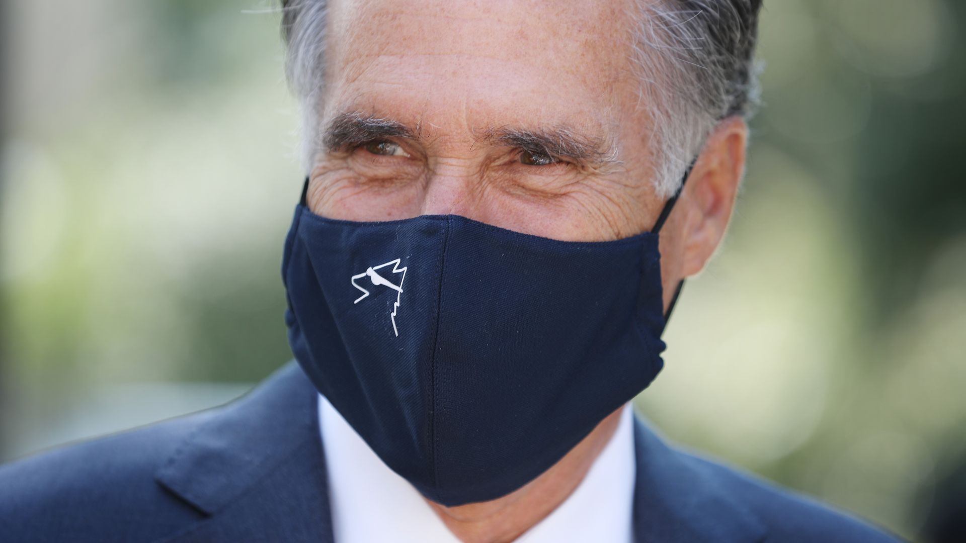 Mitt Romney wearing a face mask outside