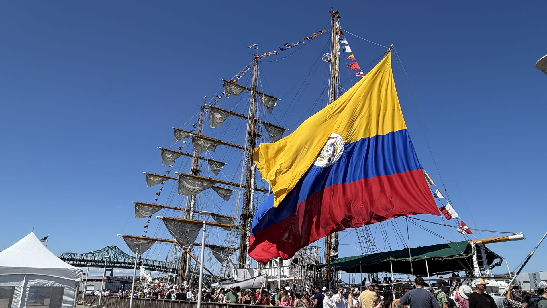A Colombian tall ship with three masts draws long lines at Pier 11 in Charlestown.