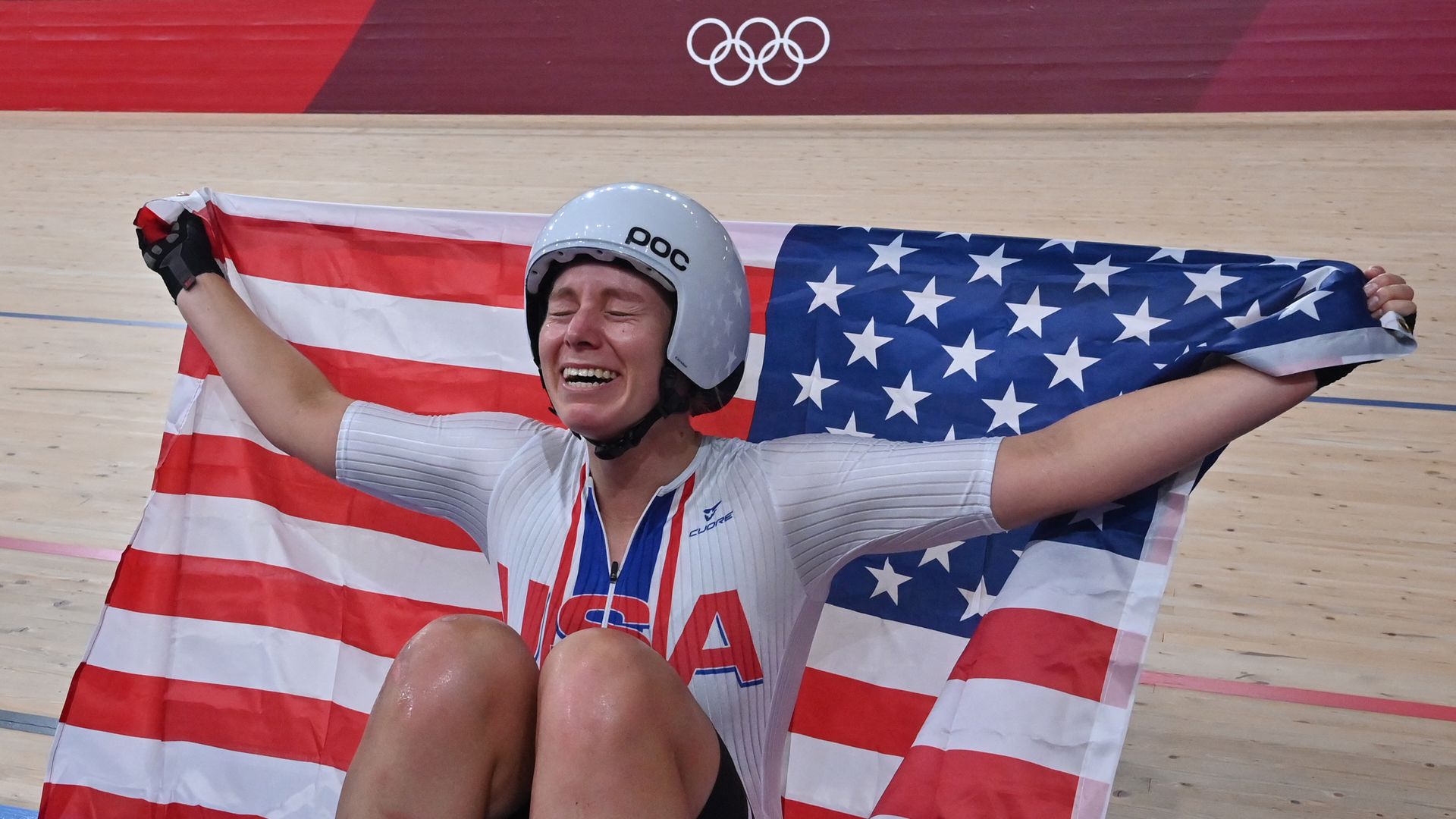 USA's Jennifer Valente poses with a flag after winning the women's track cycling omnium points race during the Tokyo 2020 Olympic Games at Izu Velodrome in Izu, Japan, on August 8