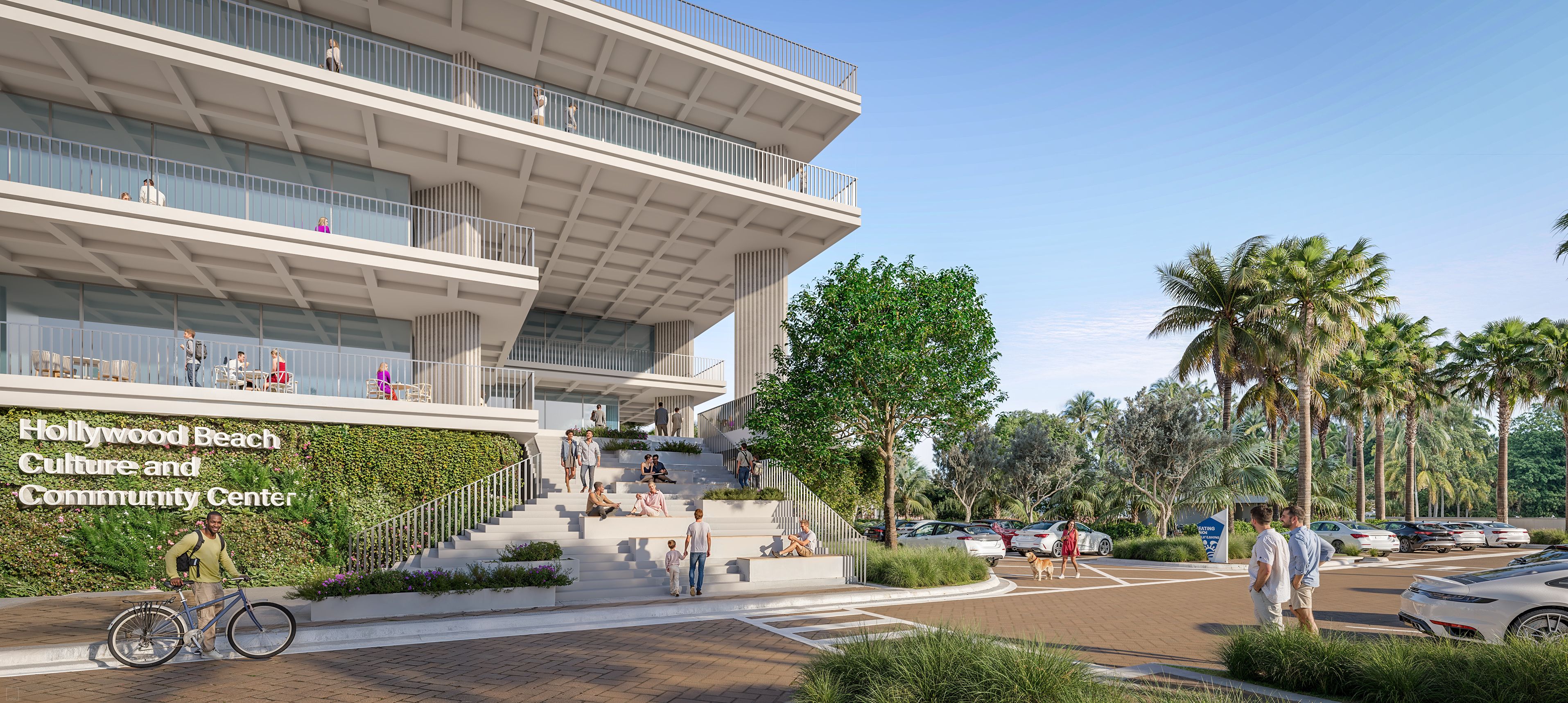 Modern building with balconies and terraces. Ivy-covered wall reads Hollywood Beach Culture and Community Center. People sit on steps; a cyclist passes; palm trees and cars in a parking lot.
