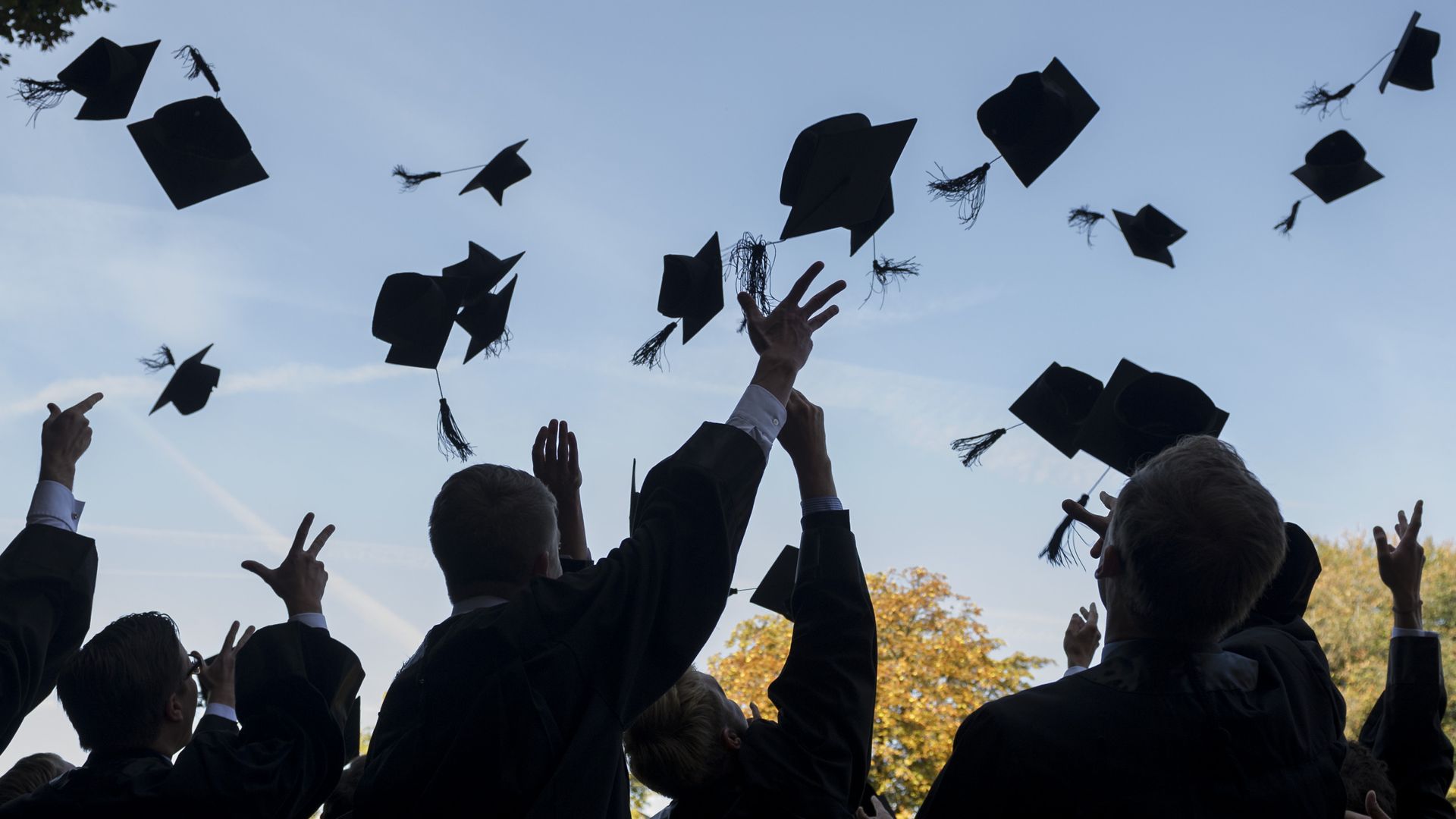 Graduation caps being thrown