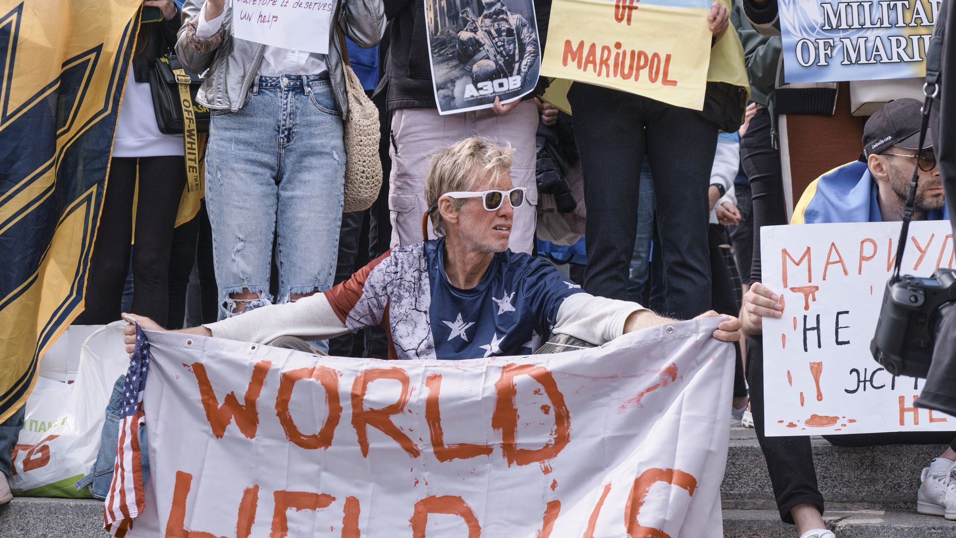 Ryan Routh holds a banner that reads 'World Help Us' during a demonstration in support of Mariupol defenders in Kyiv, Ukraine.