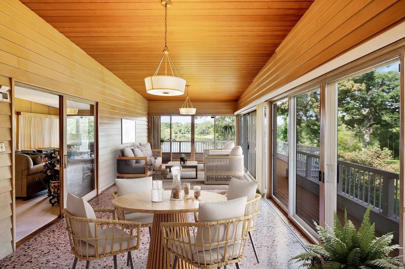 A three season porch with tables and chairs.