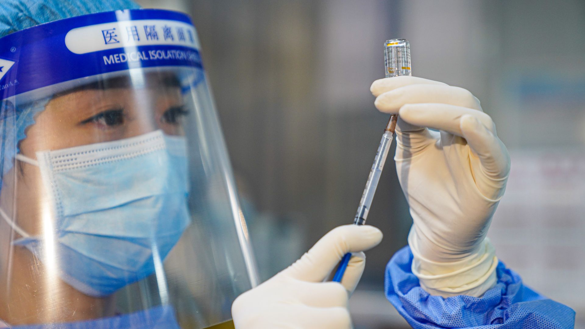 Picture of a nurse preparing a Sinovac vaccine